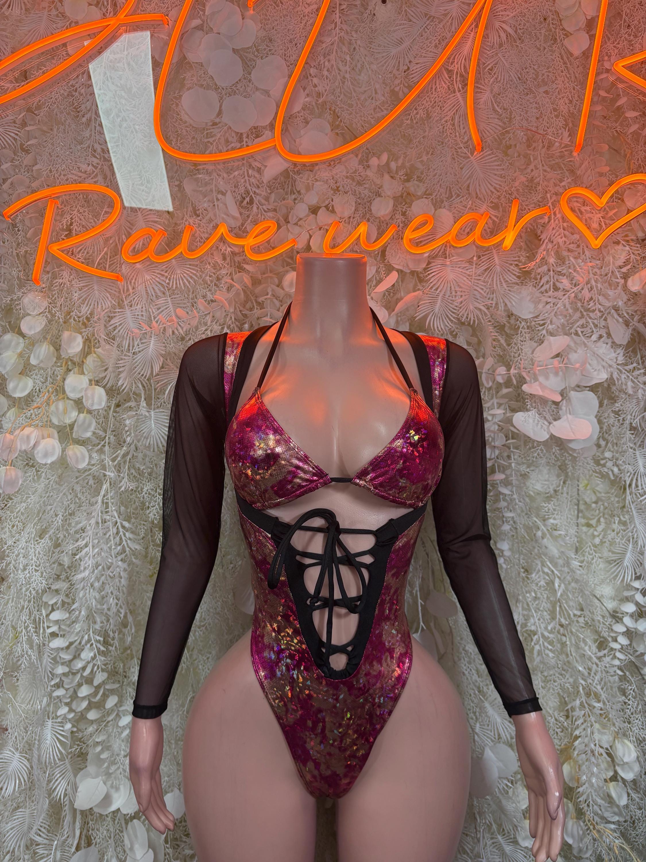 Metallic magenta one-piece bodysuit with black lace-up front and sheer long sleeves
