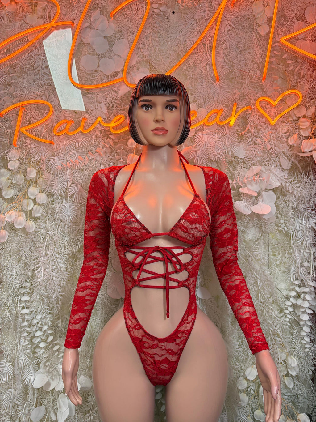 Red lace bodysuit with long sleeves and crisscross lace-up front, deep cutout
