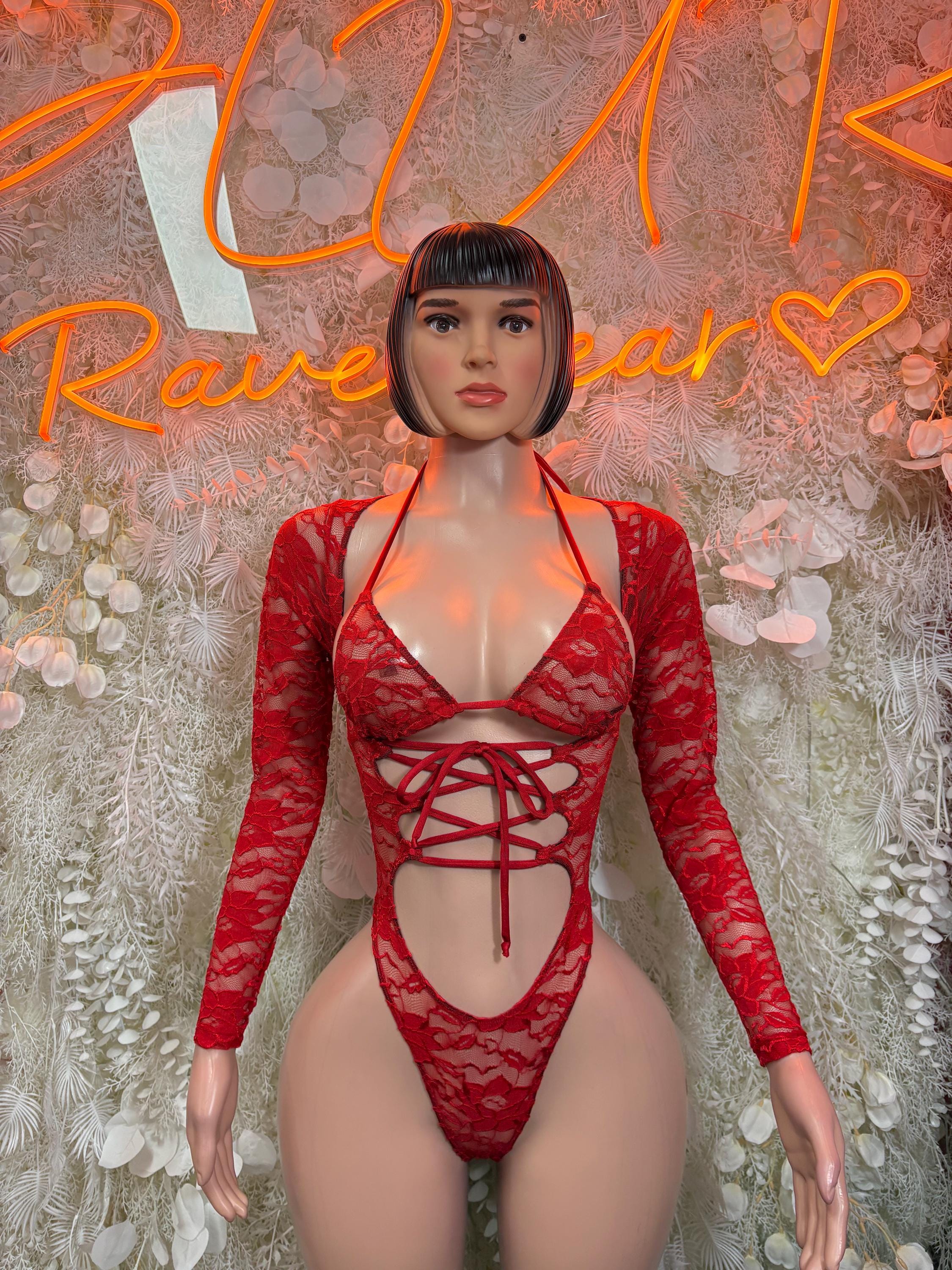 Red lace bodysuit with long sleeves and crisscross lace-up front, deep cutout