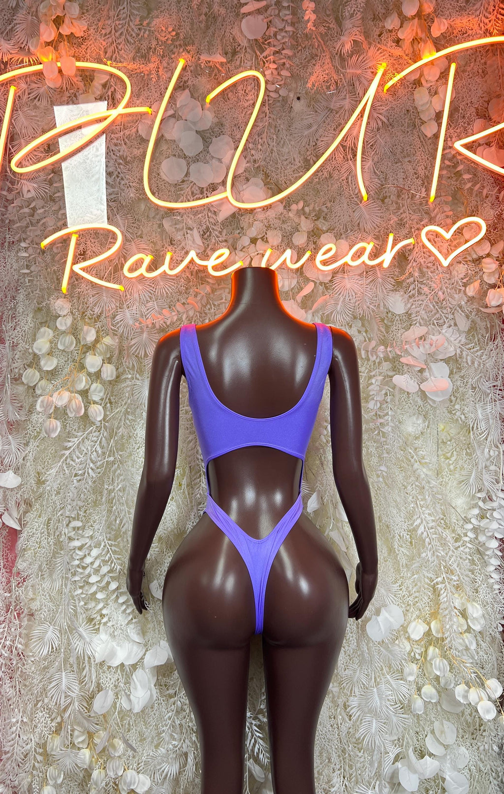 Purple long-sleeve bodysuit with scoop neck and high-cut bottom, front view