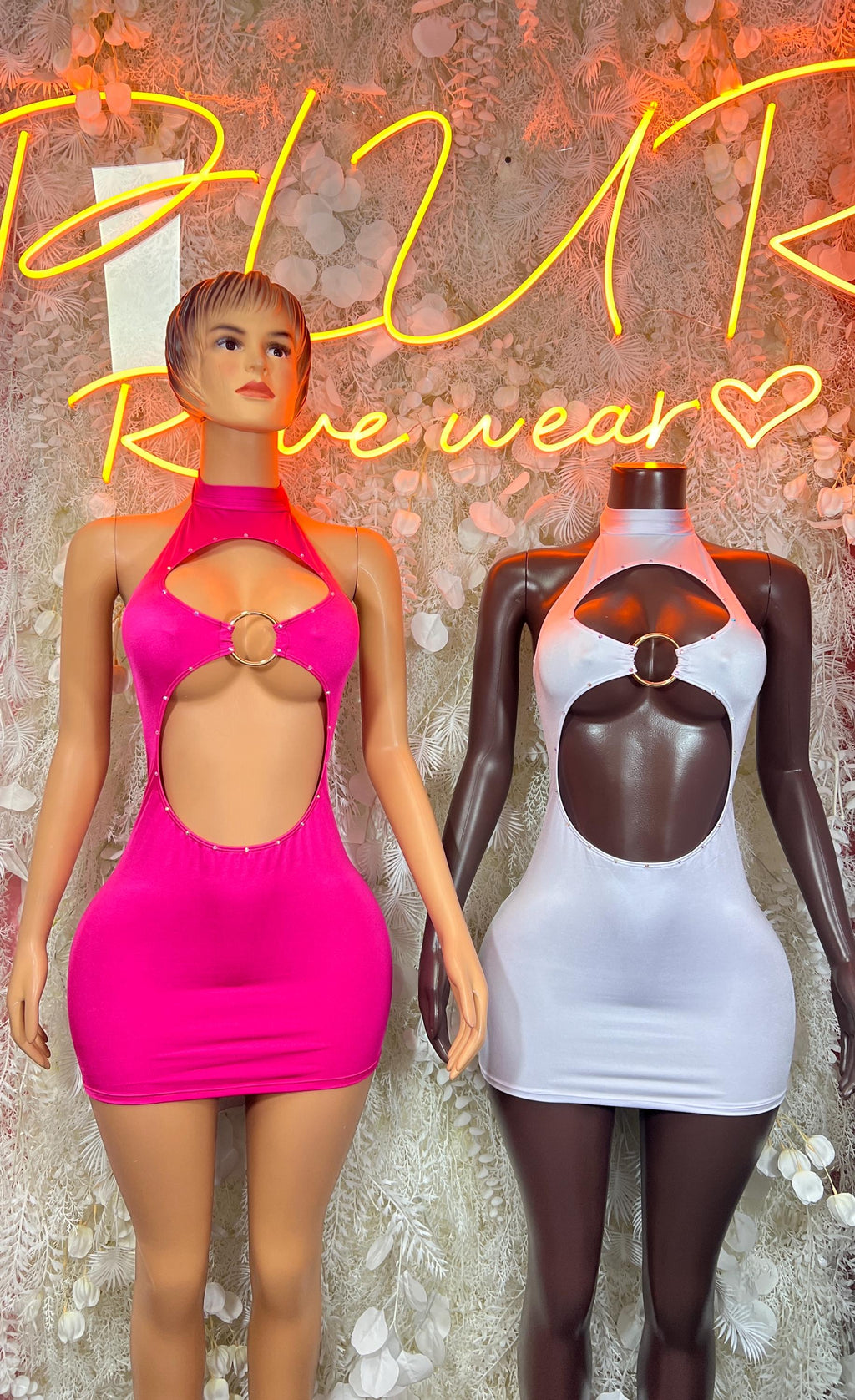 Hot pink mini dress bodysuit with halter neck; light bodysuit on mannequin