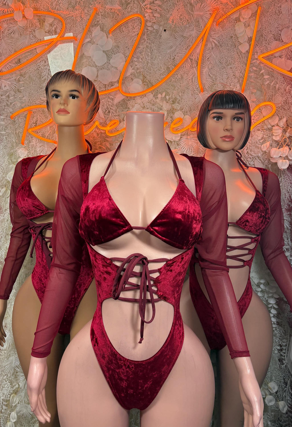 Red velvet bodysuit with lace-up triangle top, high-cut bottom, sheer long sleeves
