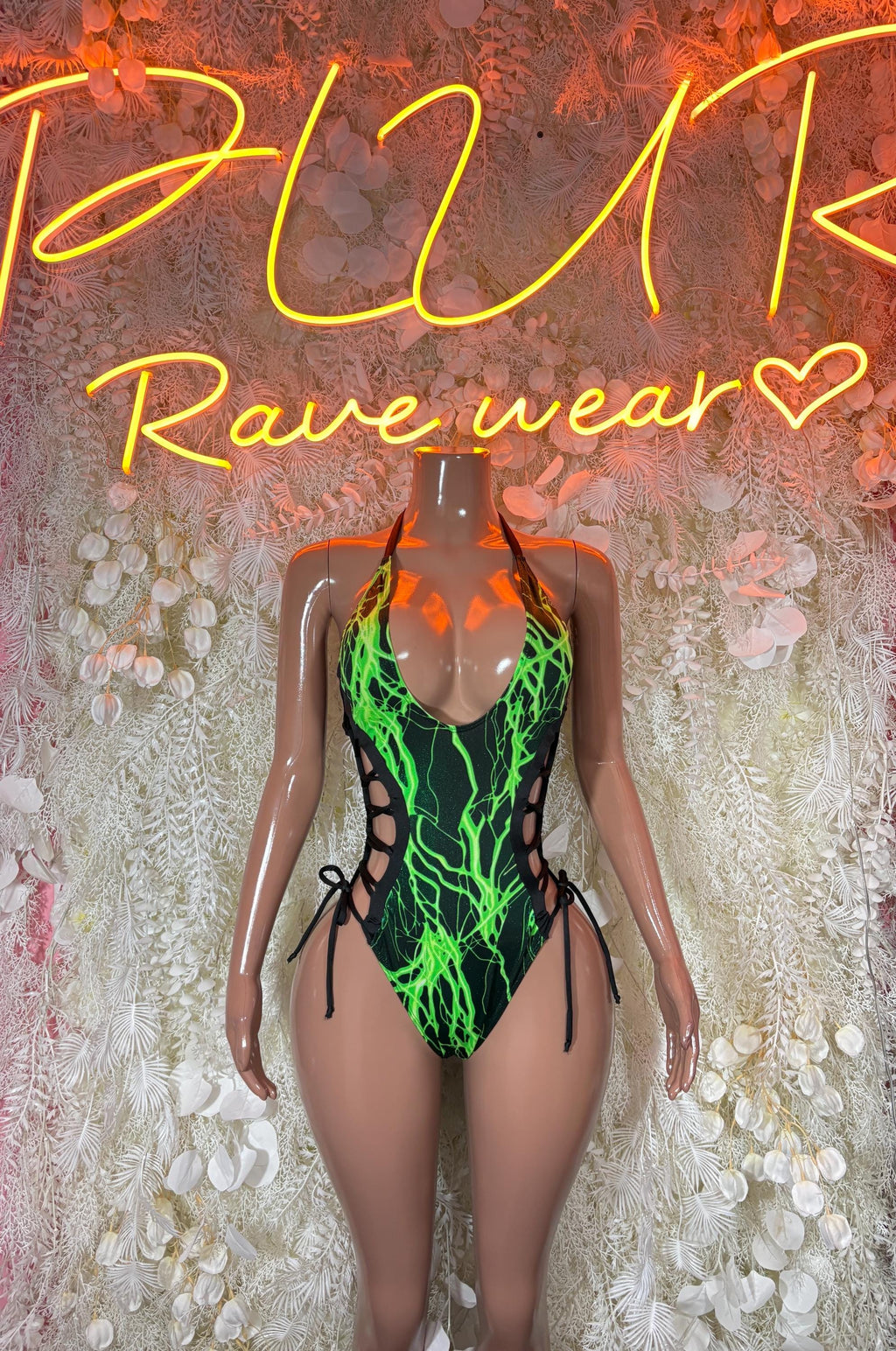 Green lightning graphic one-piece bodysuit with black side cutouts and halter straps