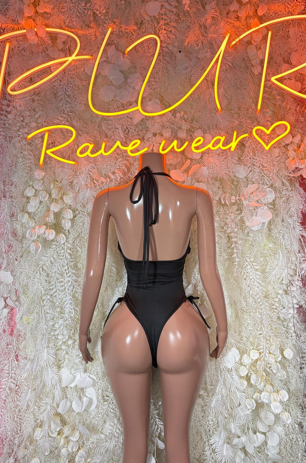 Black one-piece bodysuit back view with tie straps and high-cut legs