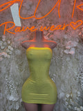 Lime green metallic strapless bodycon mini dress on mannequin, ruched fabric