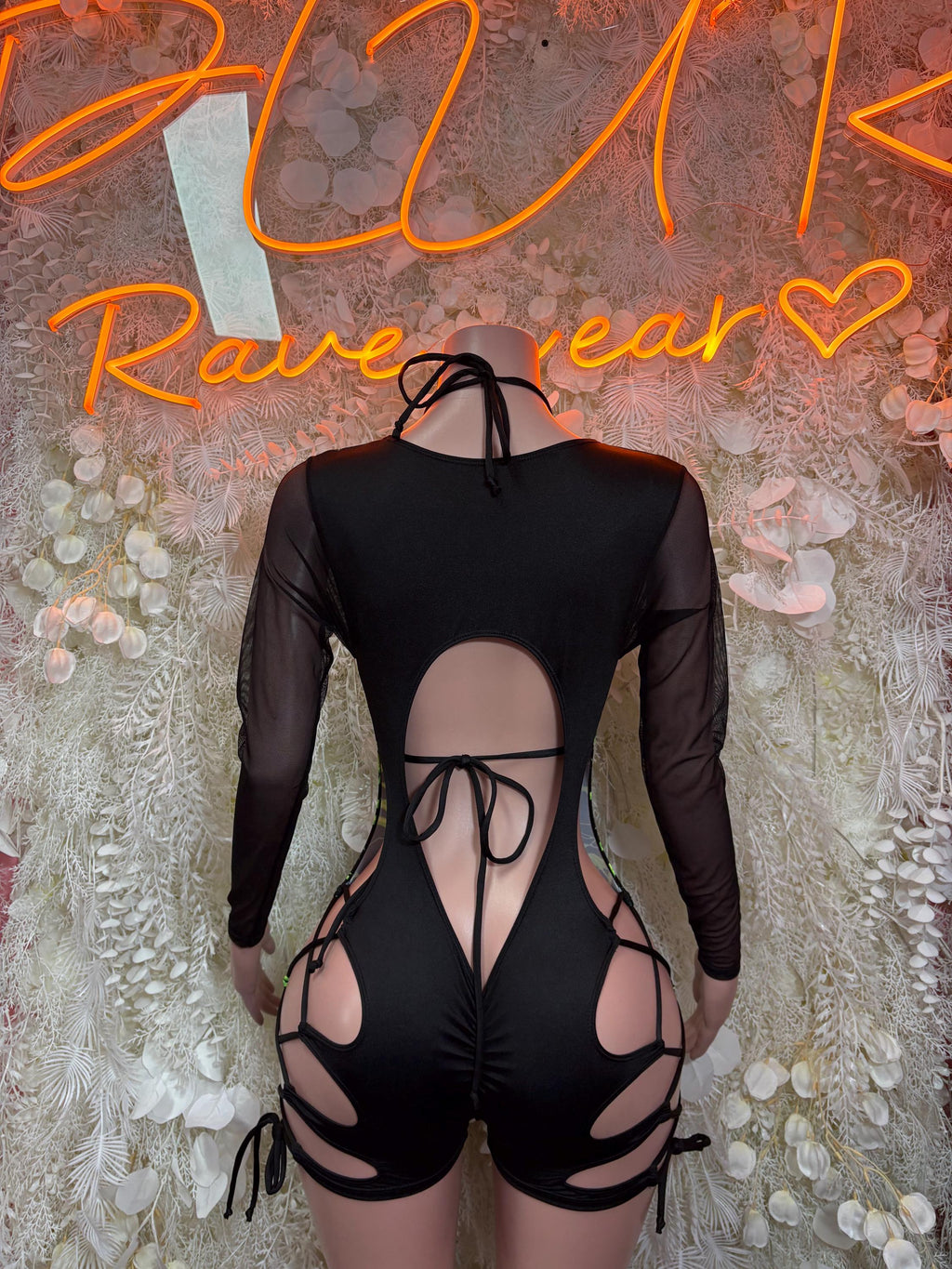 Black one-piece bodysuit with cutout back and neon green lightning print