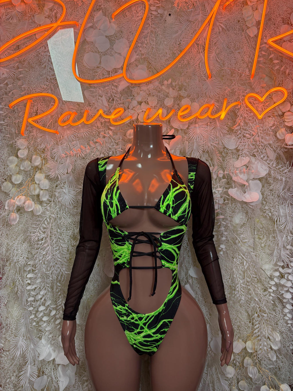 Black rave dancewear bodysuit with neon green graphic lines, long sleeves, cutout front