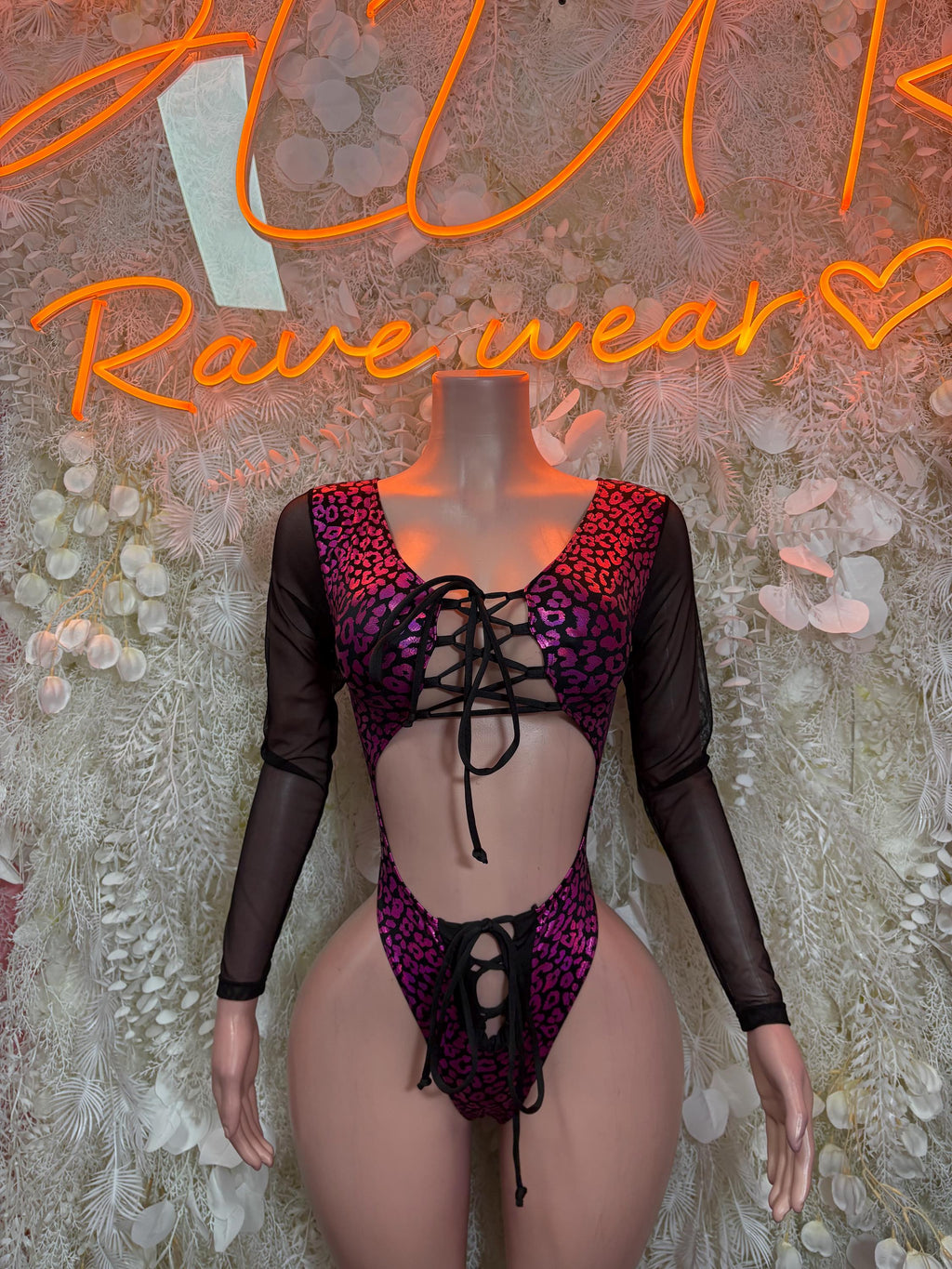 Purple leopard one-piece bodysuit with long sheer sleeves, lace-up front and back cutout