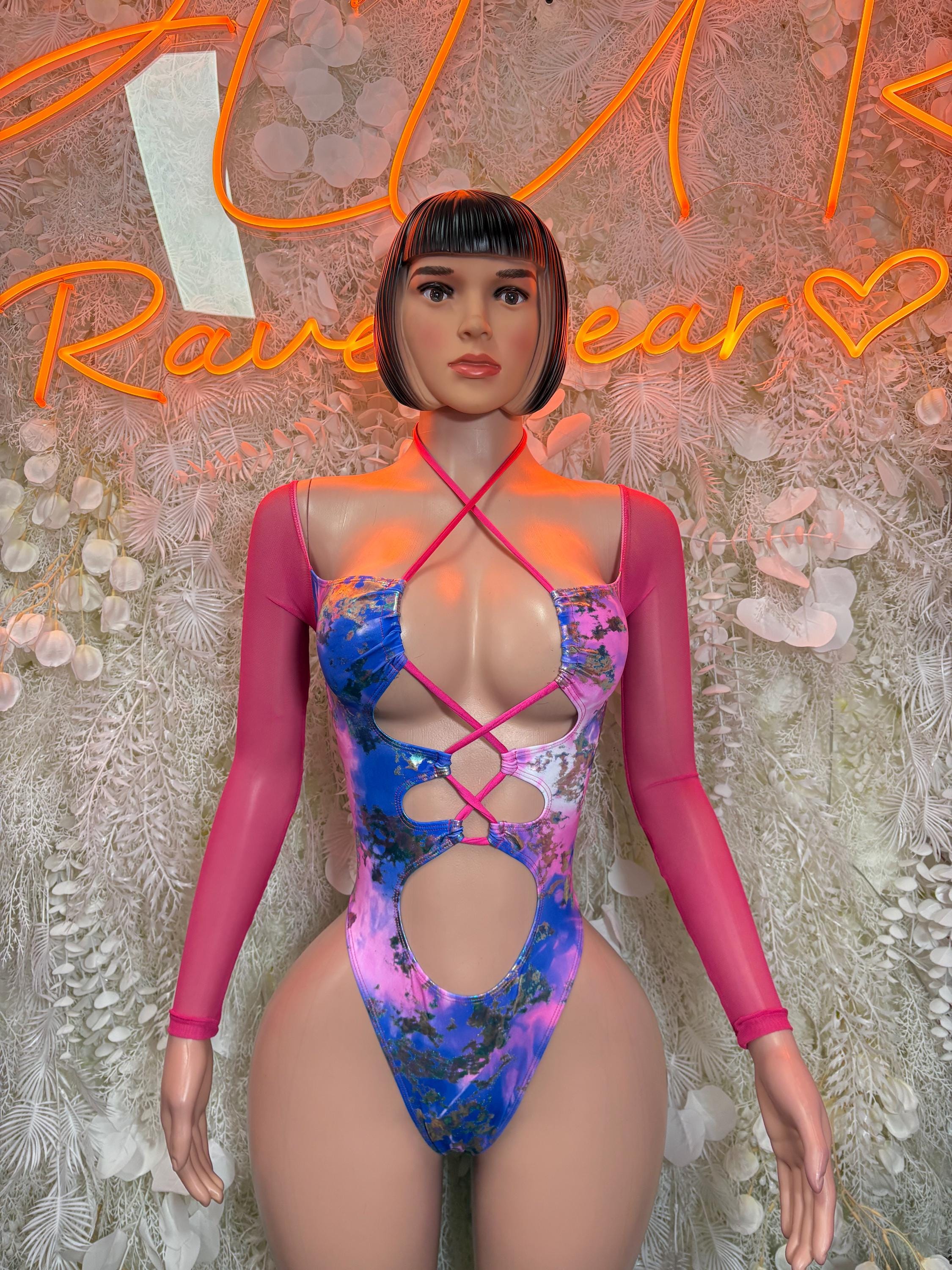 Pink and blue metallic bodysuit with crisscross straps and cheeky cutout