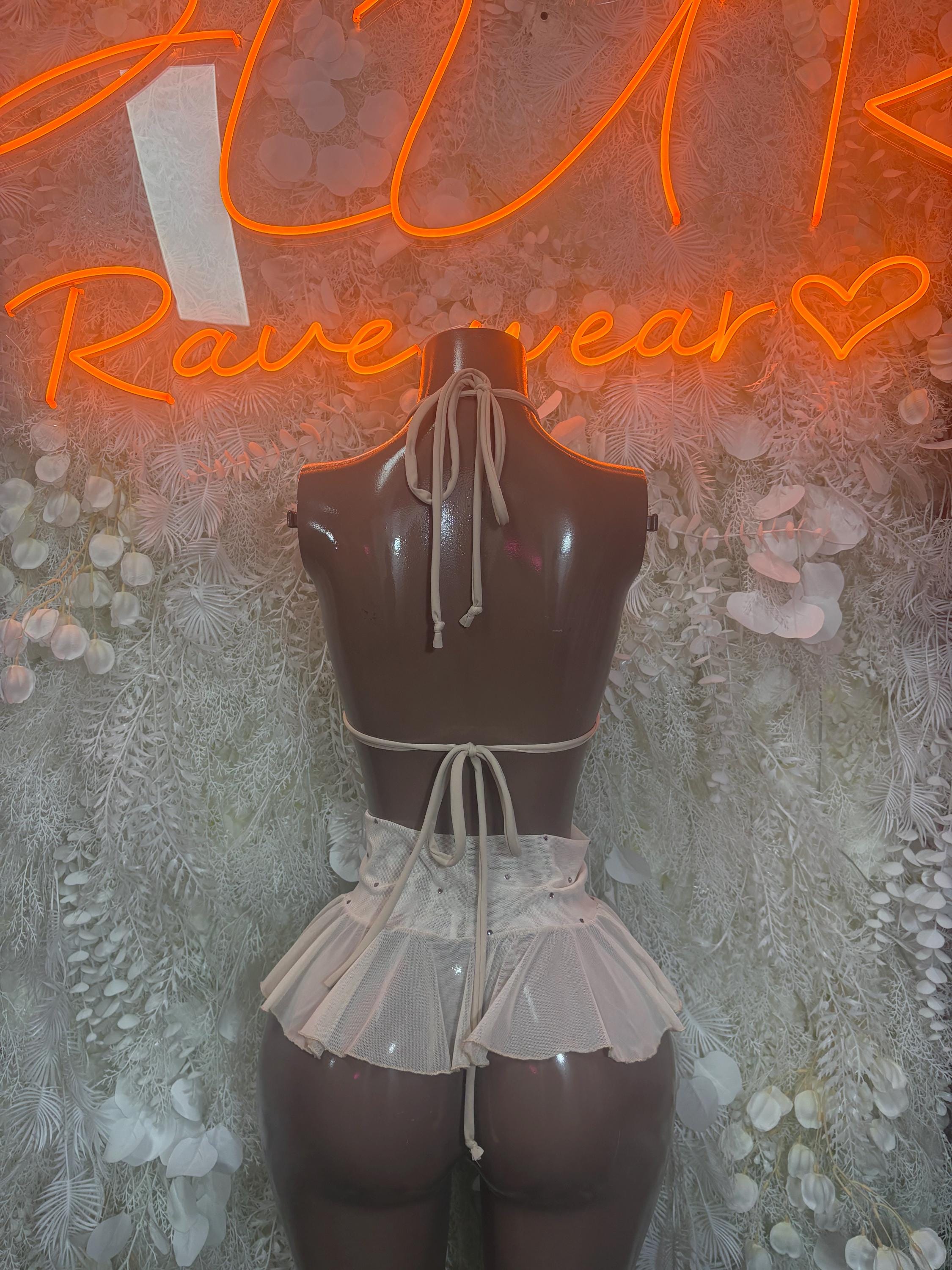 Two-piece skirt set with black open-back bodice, tied straps, and white ruffled tiered skirt