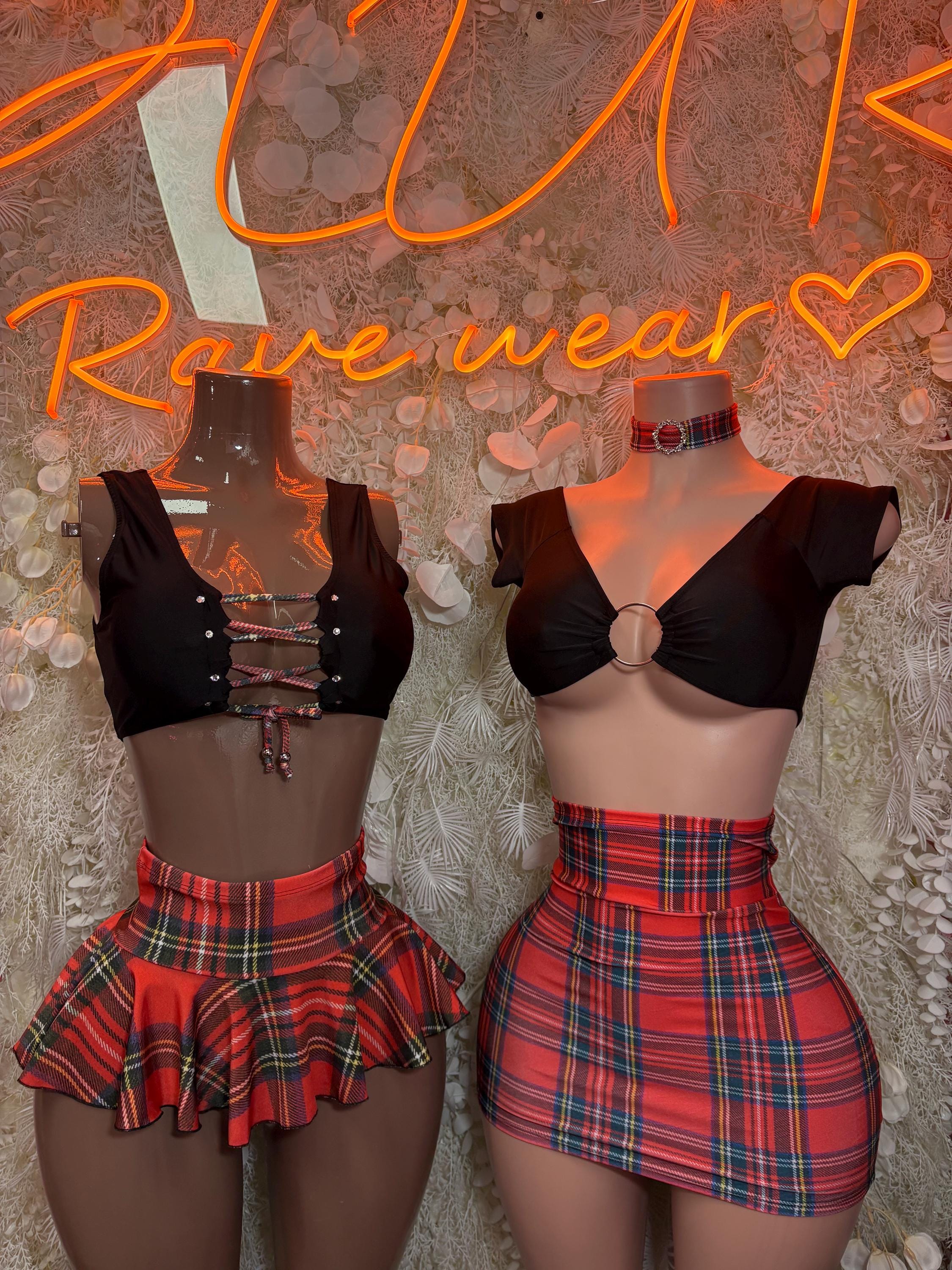 Two-piece skirt set on two models: black crop tops and red plaid mini skirts