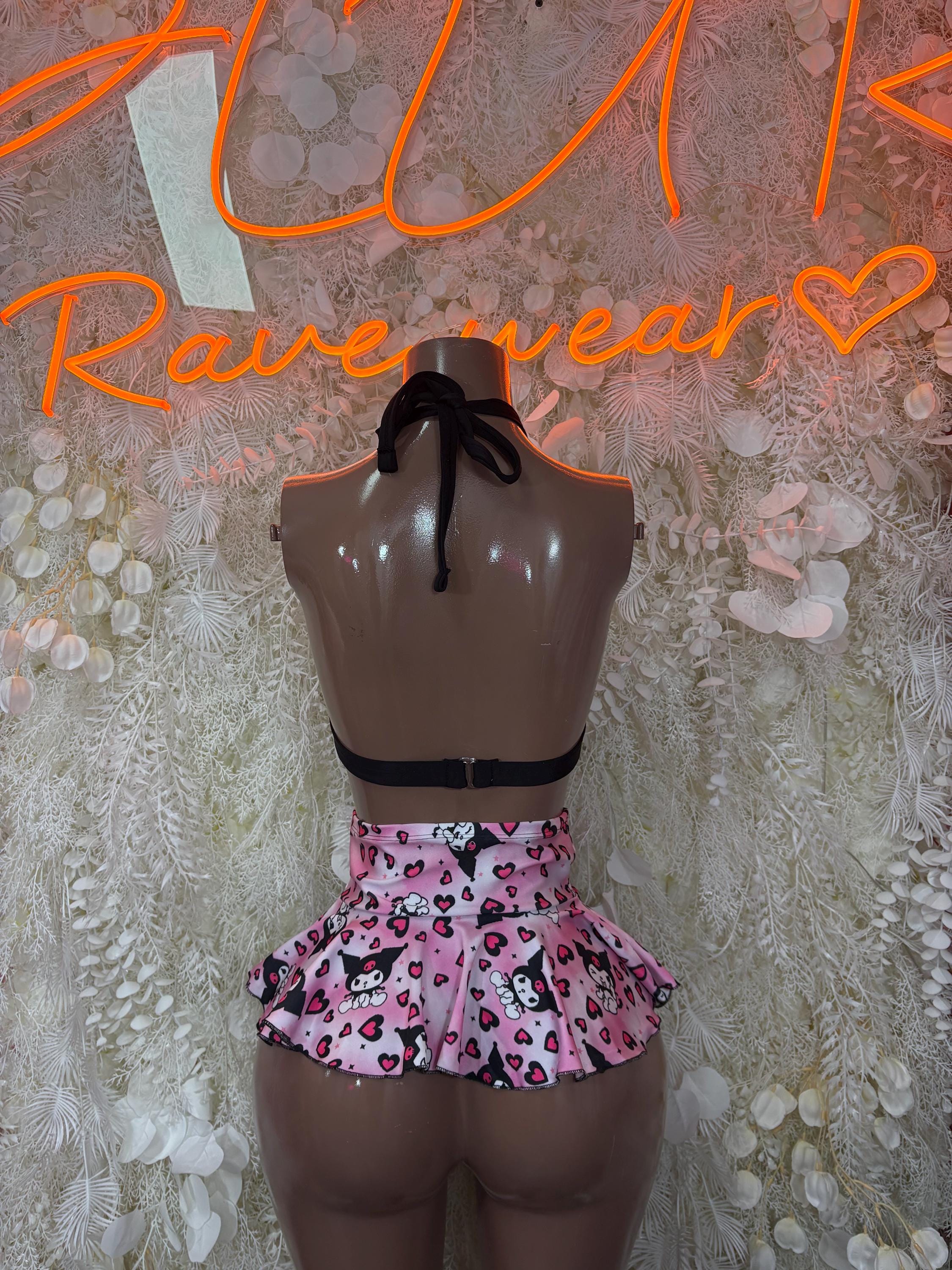 Back view of black tie triangle bra with pink heart-print pleated mini skirt