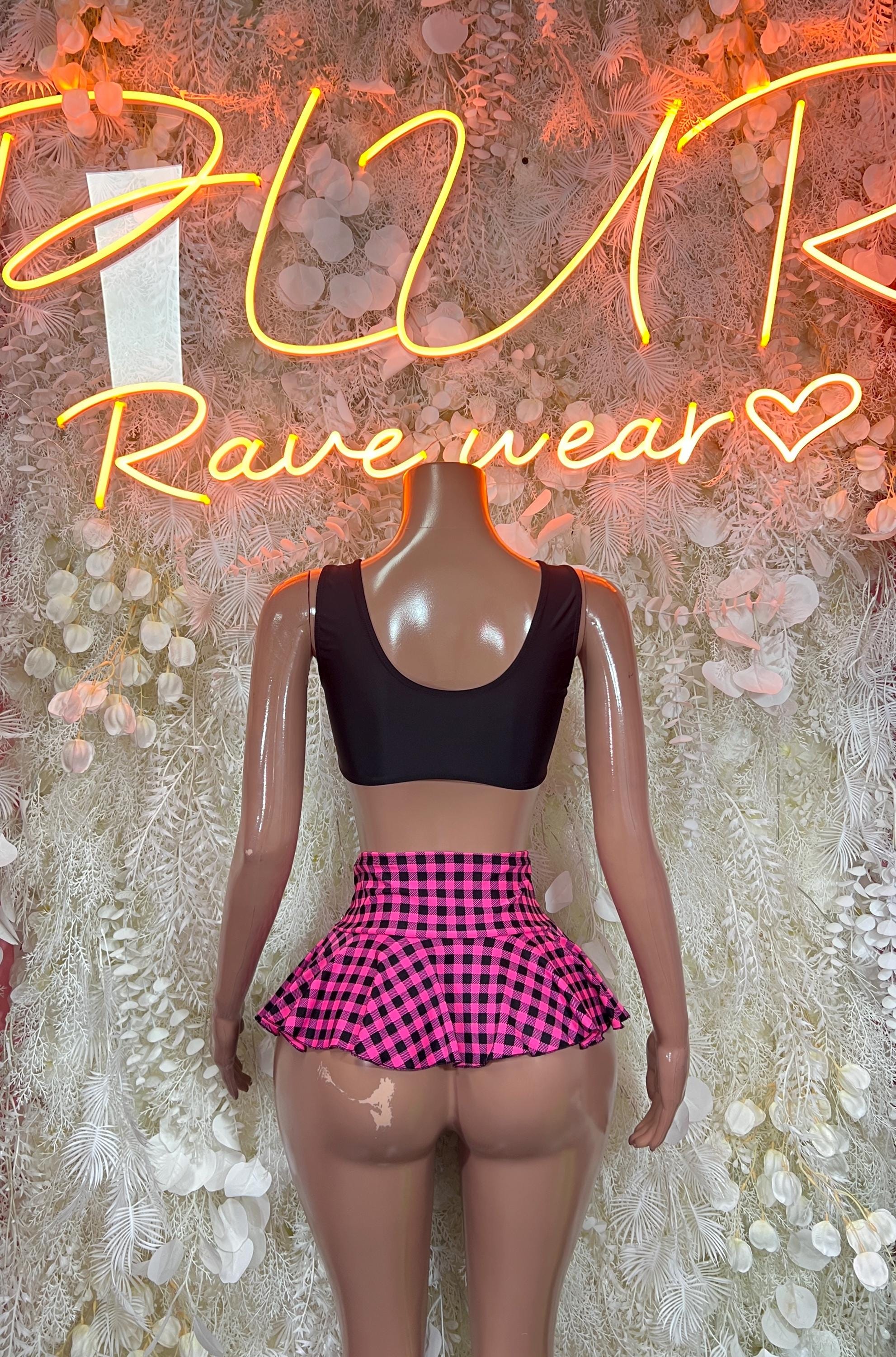 Black cropped bra top with pink plaid flared mini skirt, rave outfit