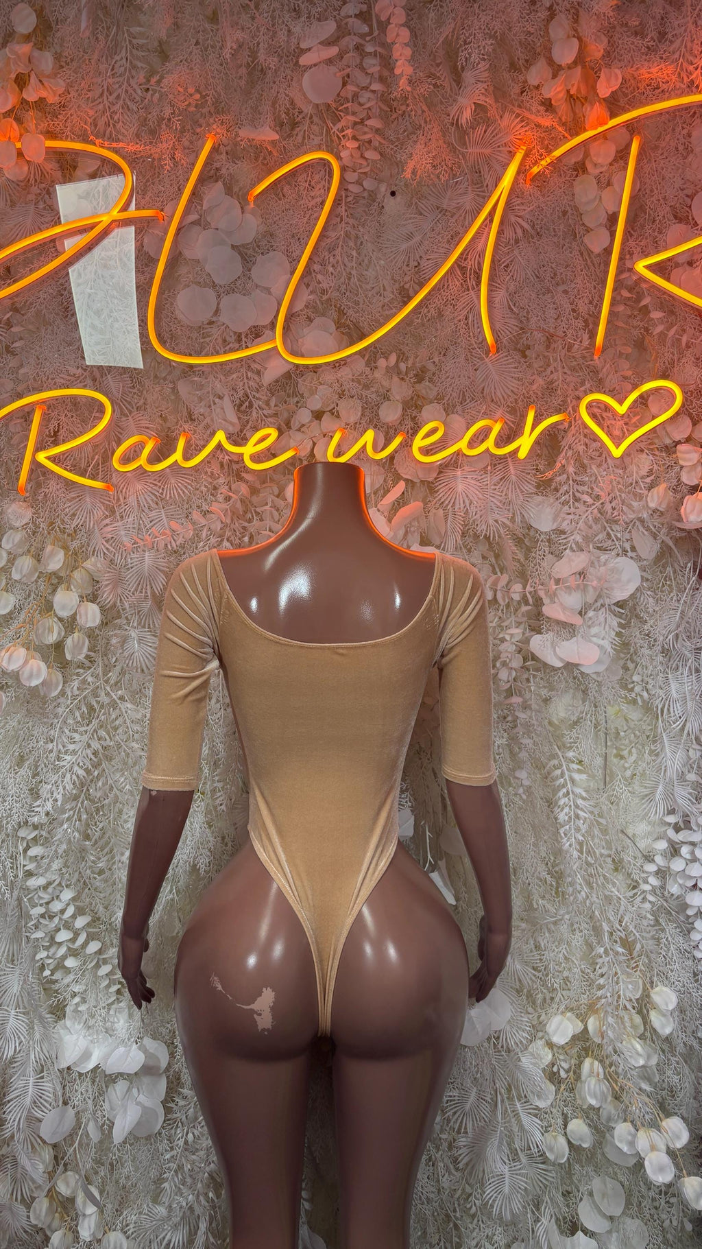 Nude velvet long-sleeve one-piece bodysuit with front lace-up and deep V neckline