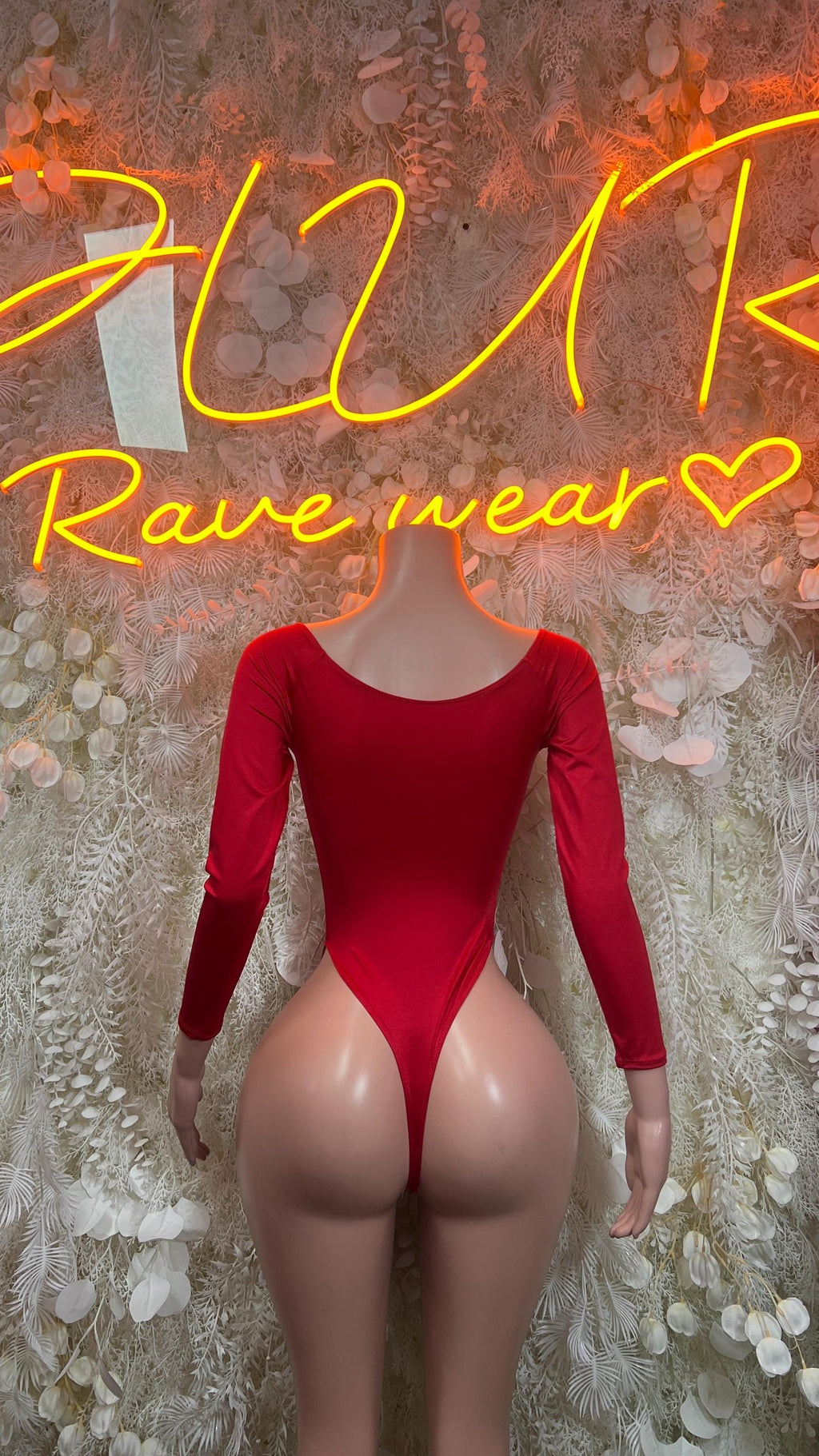 Red long-sleeve one-piece bodysuit with deep V front and high-cut bottoms
