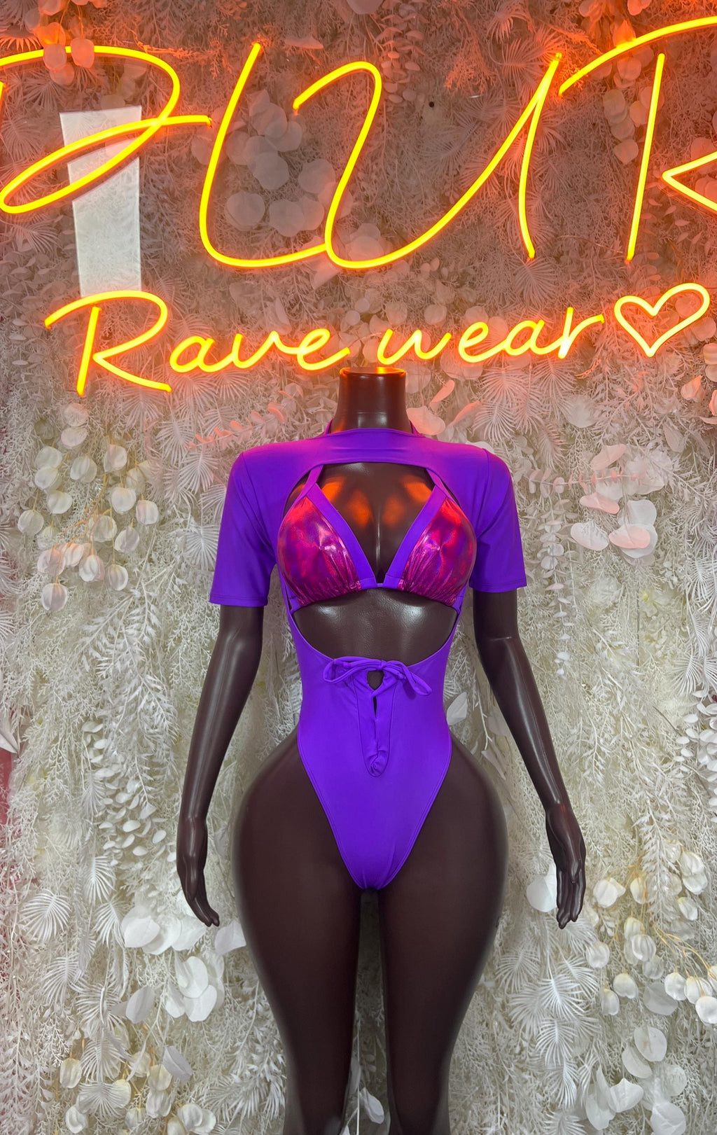 Purple one-piece dance outfit with cutout back, short sleeves, and pink mesh straps in front