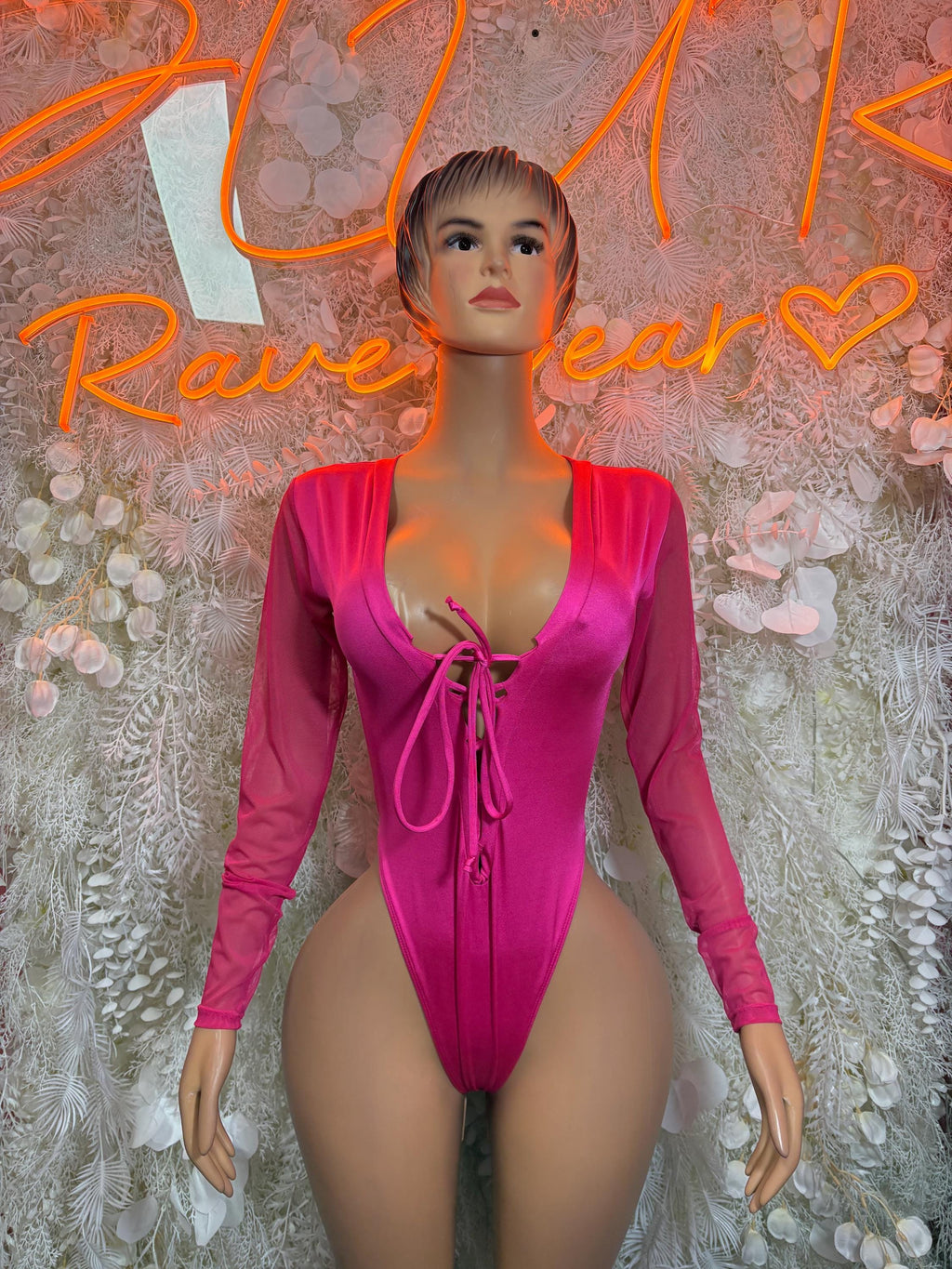 Pink long-sleeve bodysuit with V-neck and lace-up front