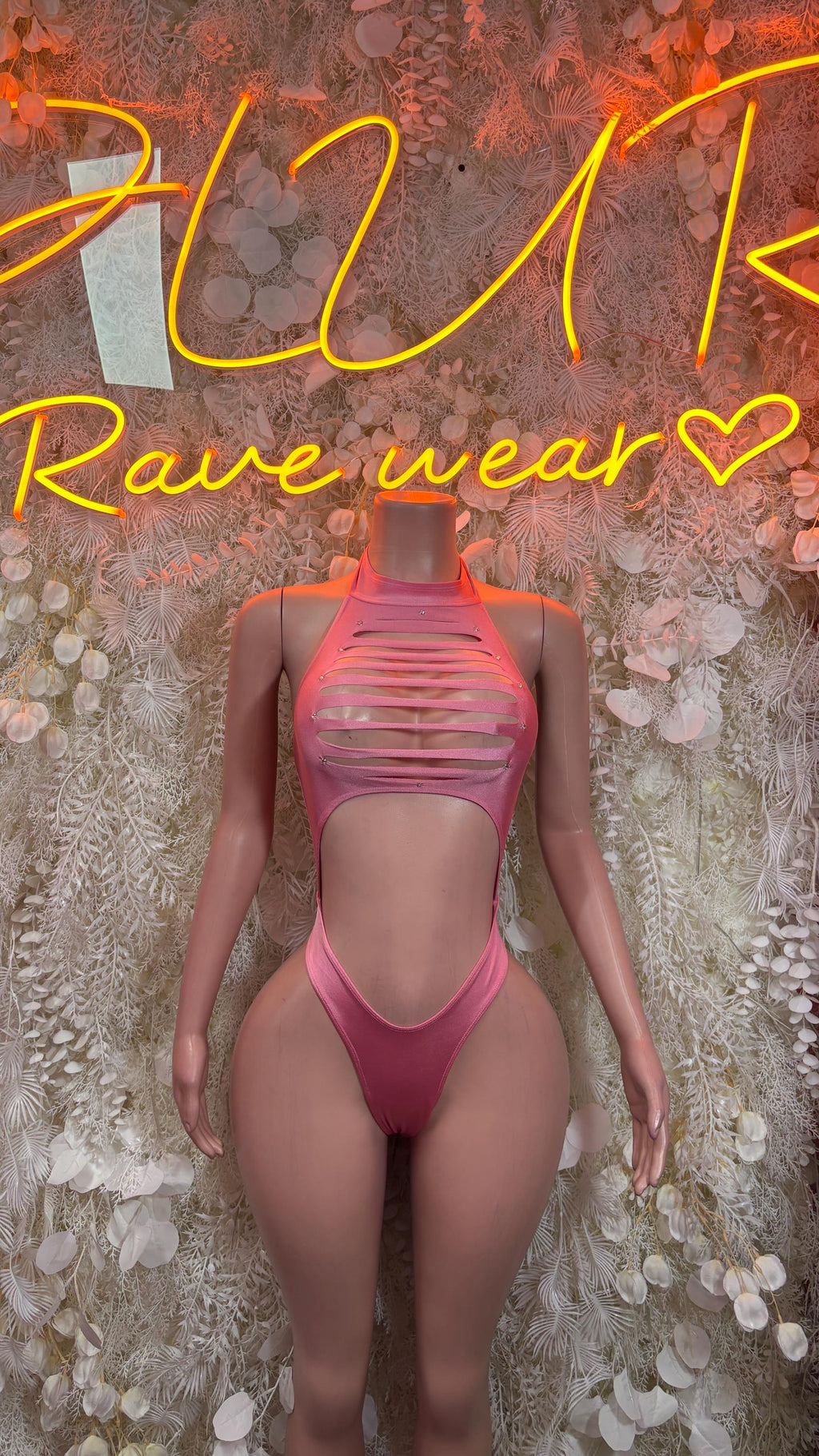 One-piece bodysuit in light pink, high-cut legs and strappy back with neckline cutout