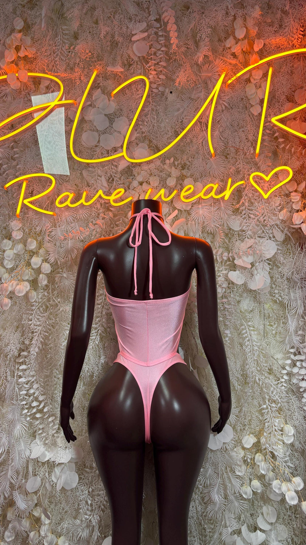 Baby pink tie-strap bodysuit with plunging front and thong-style cut