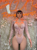 Pink lace one-piece bodysuit with long sleeves, V-neck front and corset-style lace-up