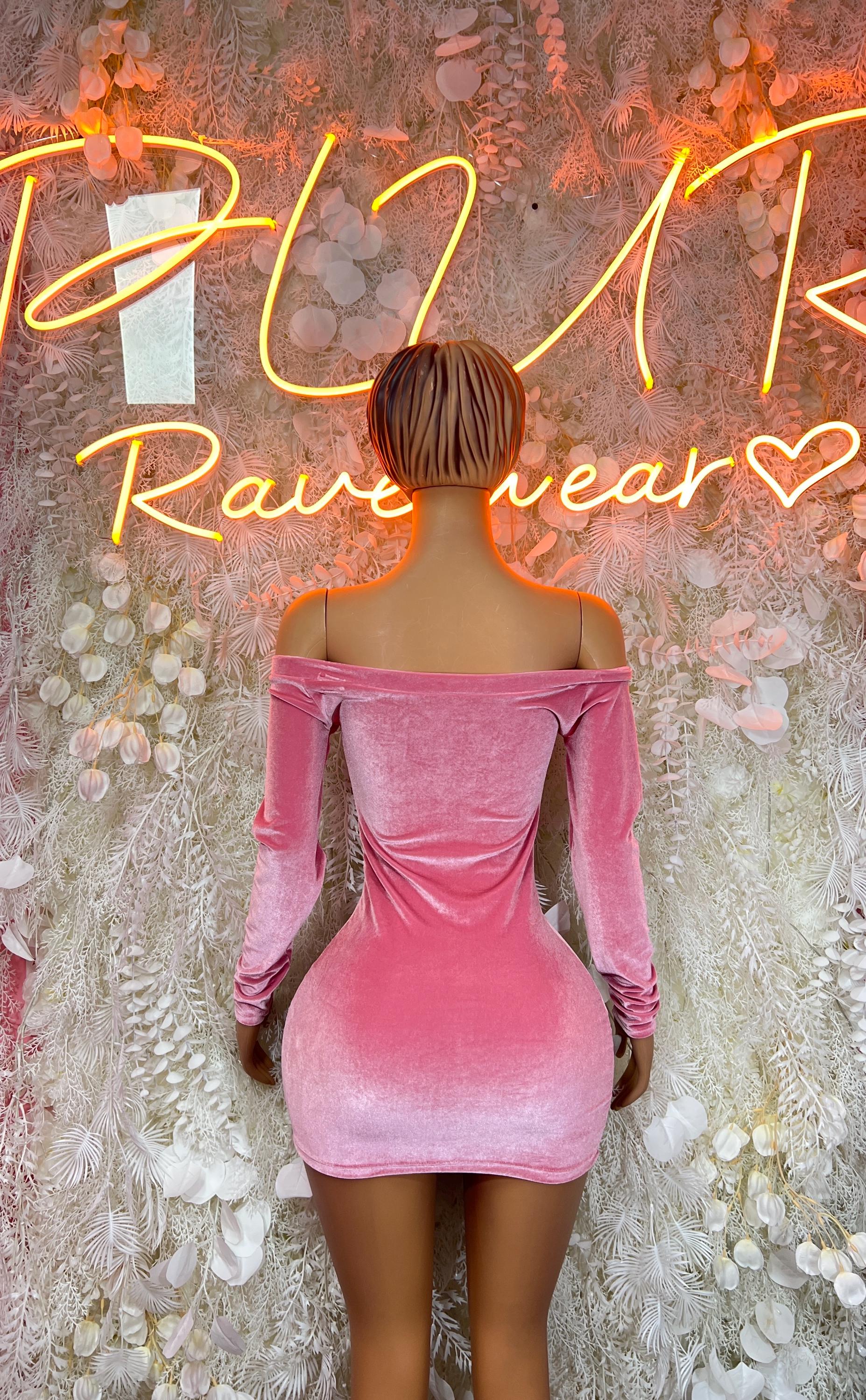 Back view of pink velvet off-shoulder mini dress with long sleeves and ruched fit.