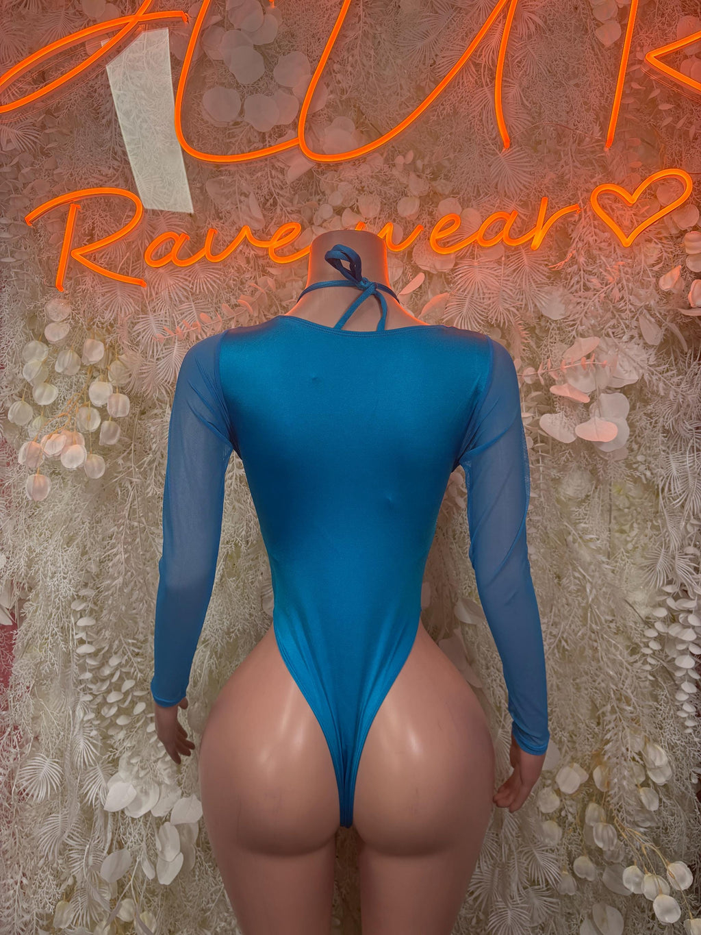 Blue one-piece bodysuit with long sleeves, low back and small keyhole opening