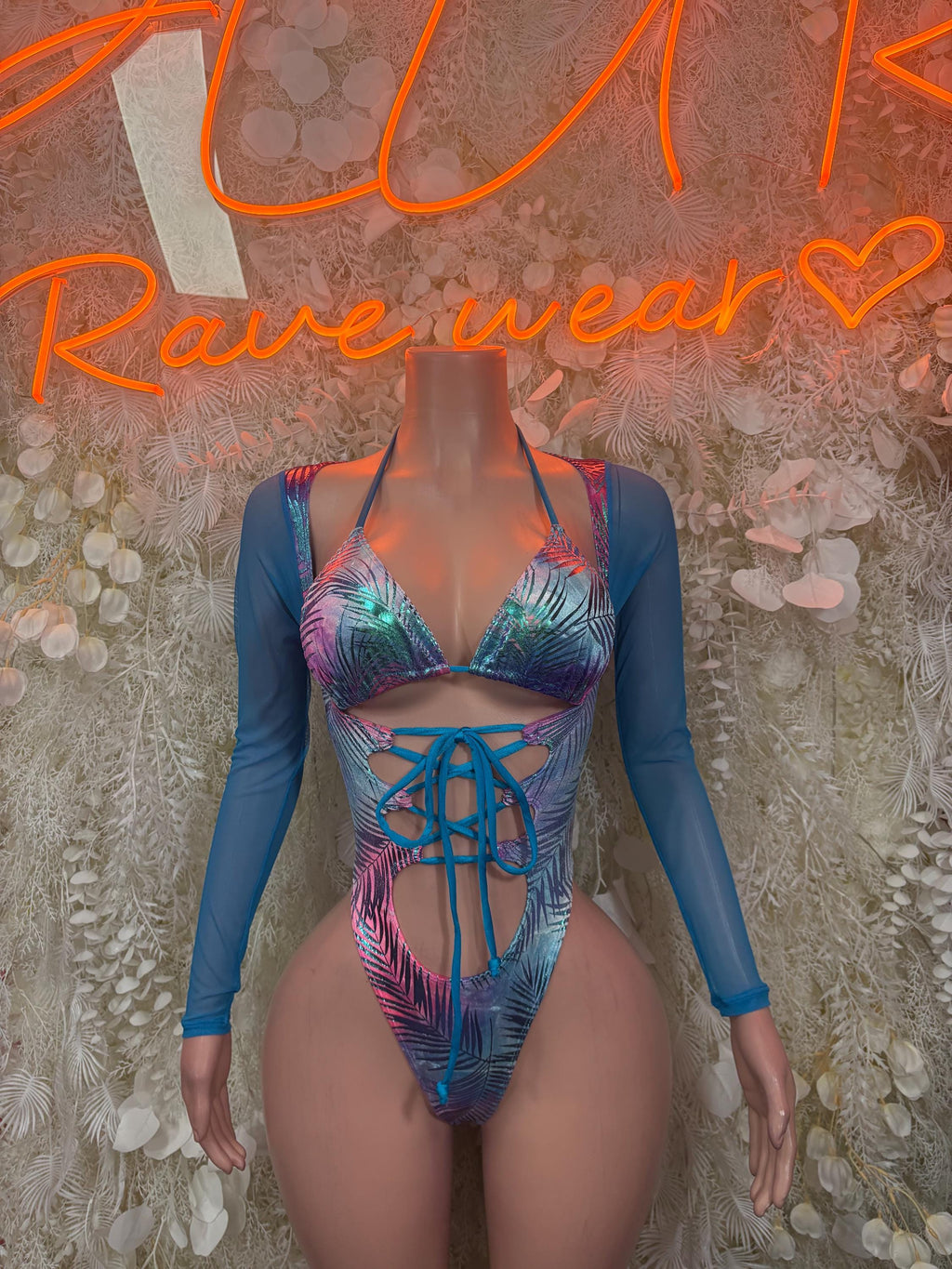 Blue one-piece bodysuit with long sleeves and tropical palm print, front lace-up cutout