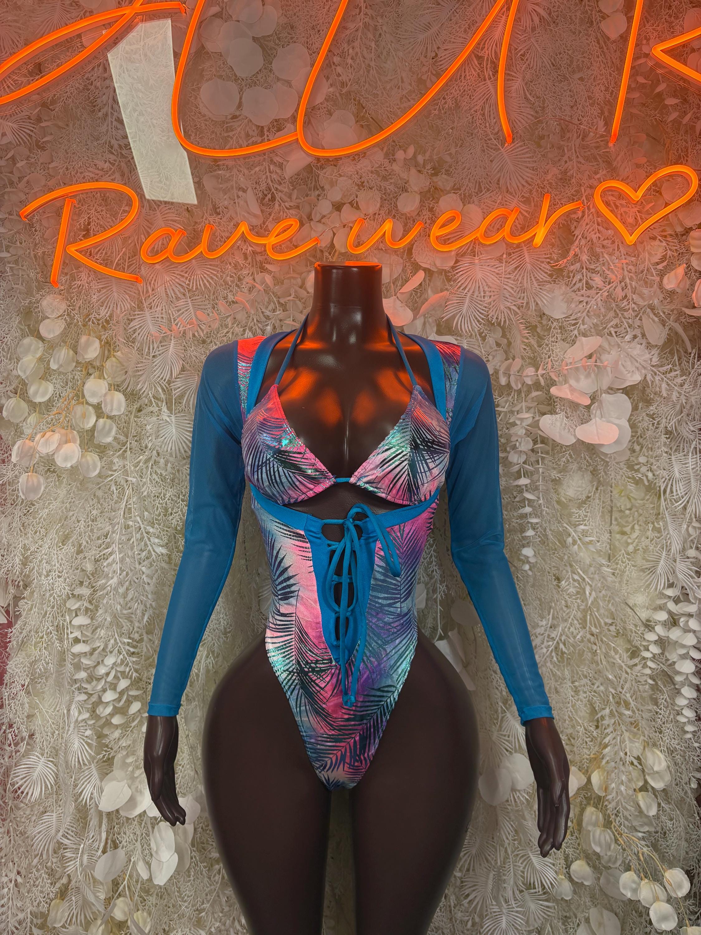 Blue one-piece bodysuit with long sleeves, tropical palm print and center lace-up