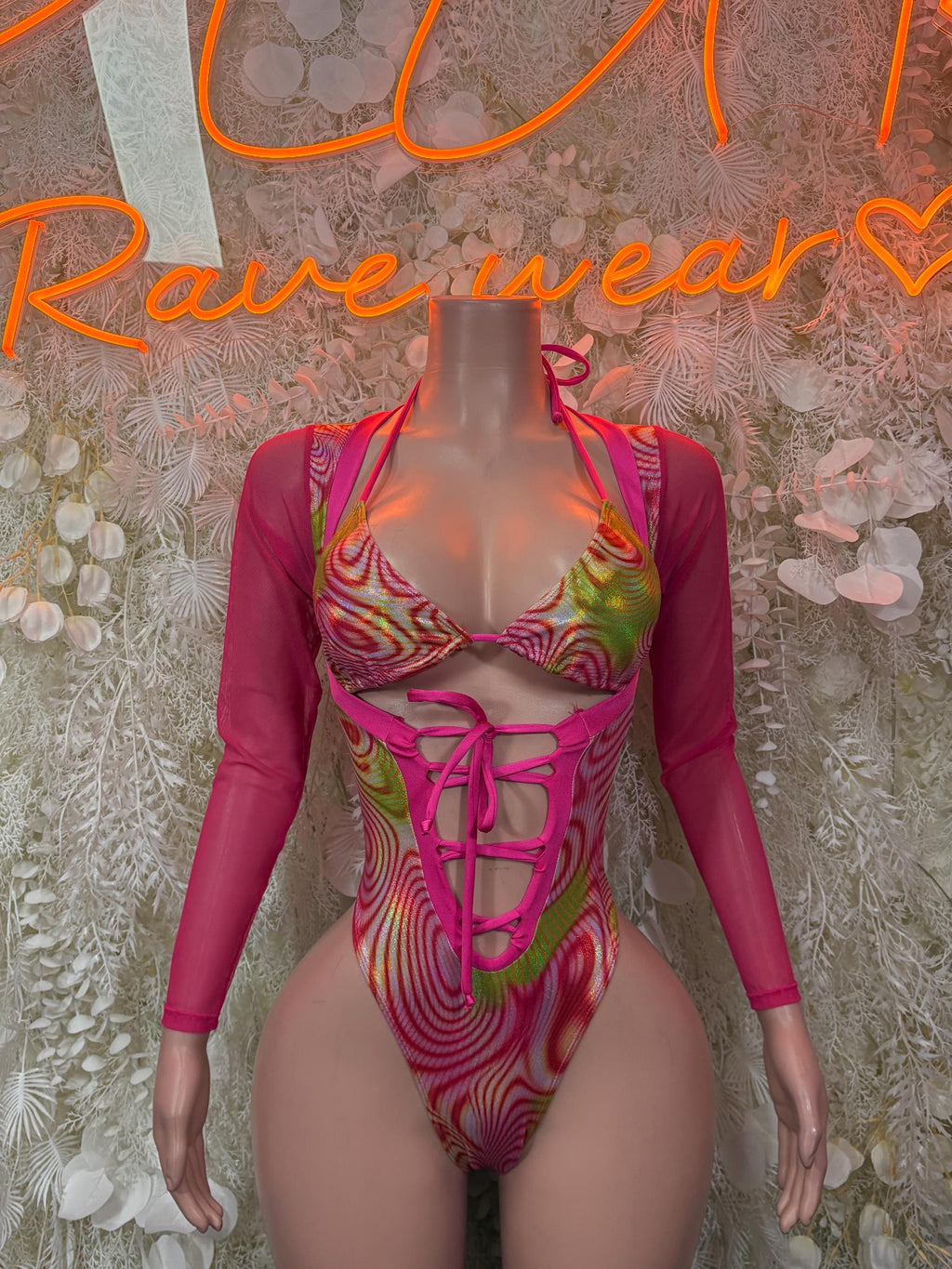 Pink and green patterned metallic-look bodysuit with long sleeves and front lace-up