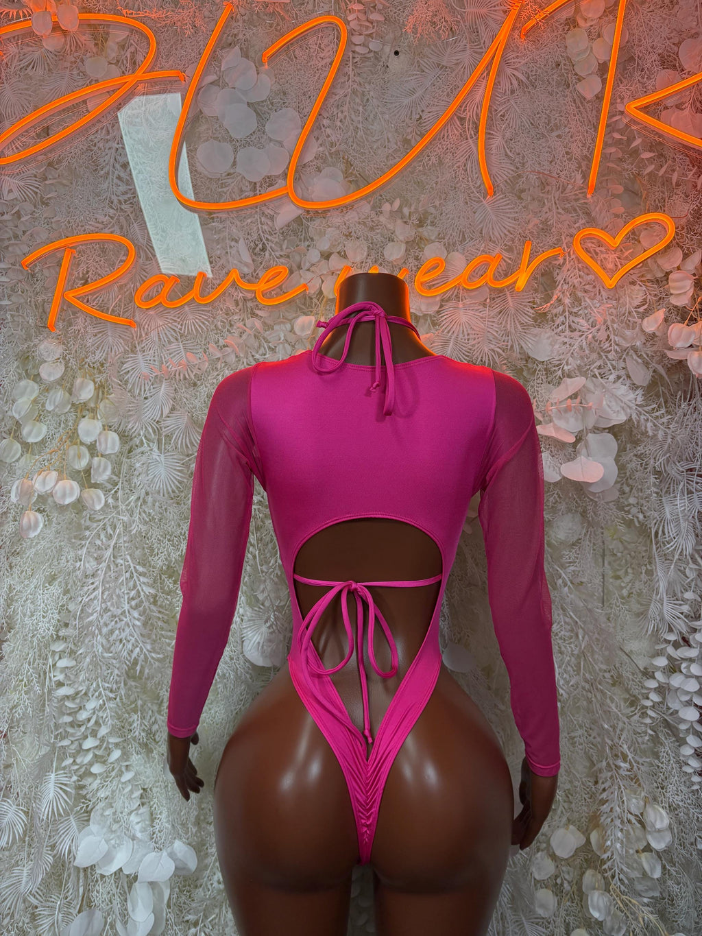 Magenta backless bodysuit with tie bow at neck, neon green/pink pattern, lace-up back