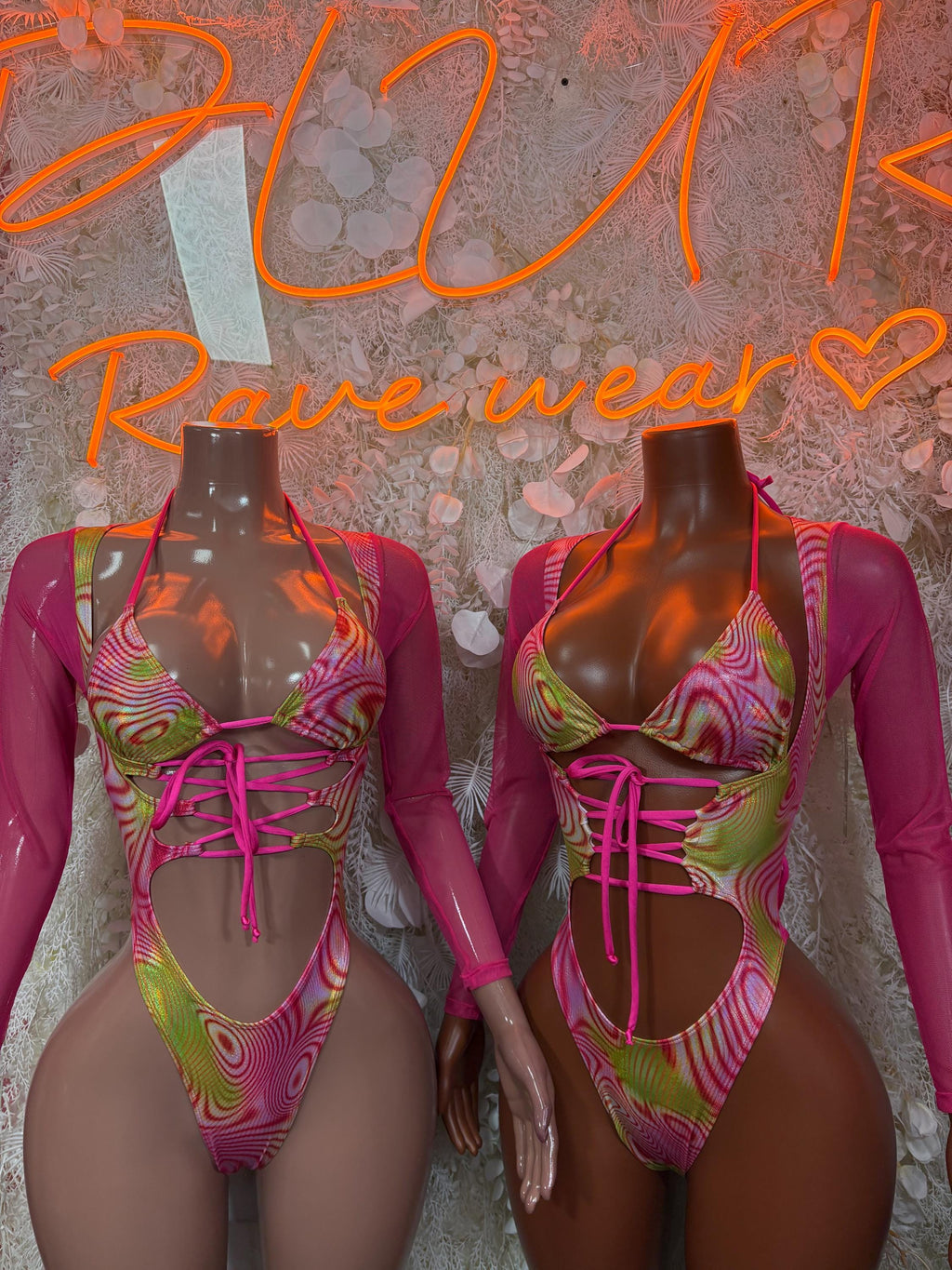 Neon pink-green bodysuit front detail with long sleeves and crisscross lace-up front
