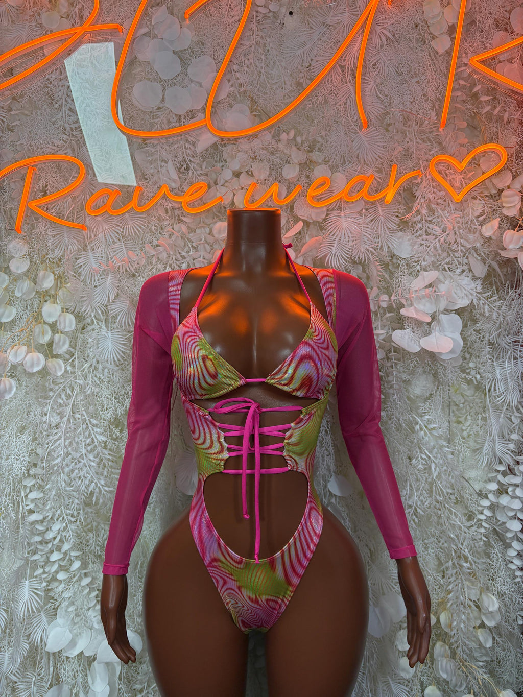 Magenta bodysuit with neon green/pink pattern, long sleeves, lace-up front cutout