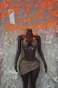 Leopard print mini skirt with black trim, high-waisted, curved front hem
