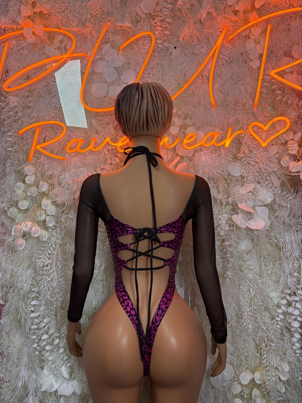Purple cheetah-print one-piece bodysuit with open back lace-up and sheer black sleeves