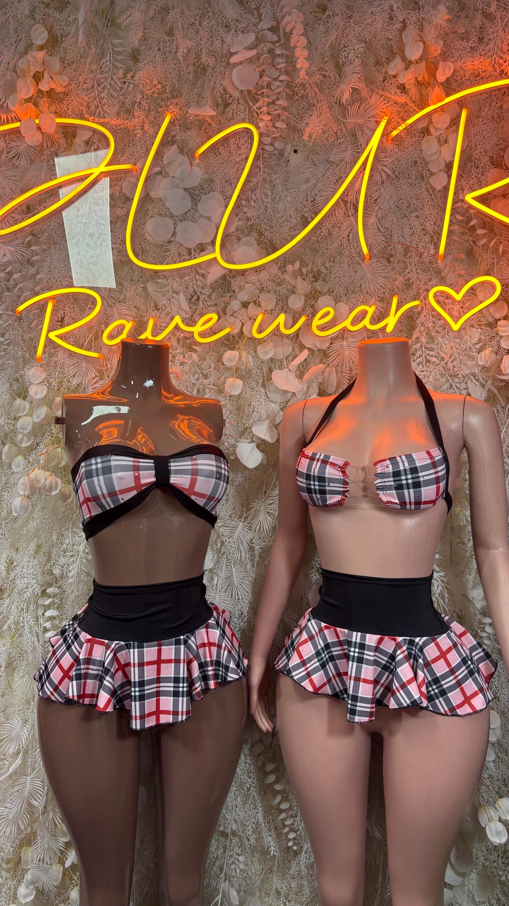 Pink-and-black plaid two-piece skirt set with strappy bra and pleated ruffle skirt