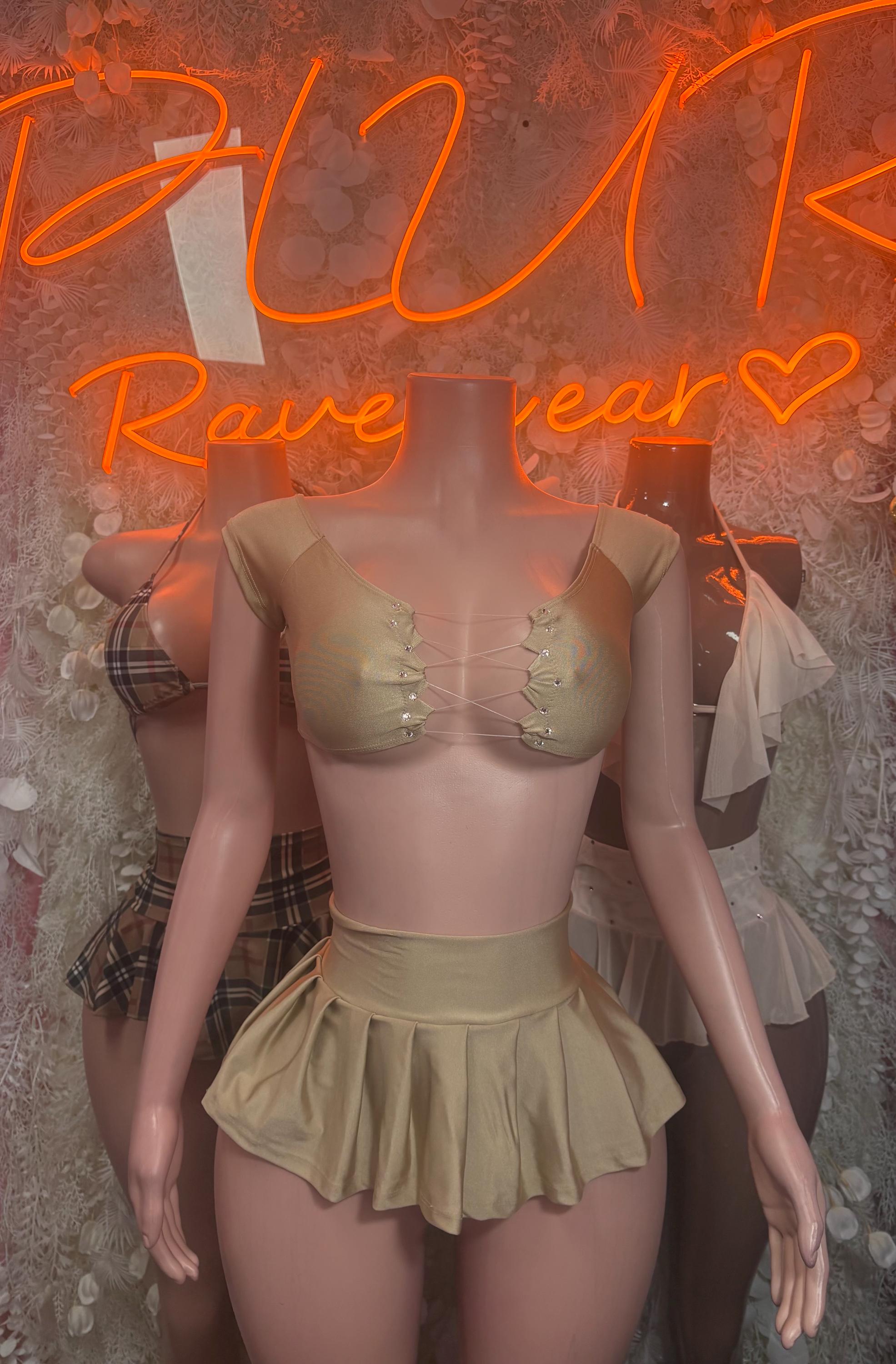 Two-piece skirt set with pale nude triangle top, gathered mini skirt, and tie back