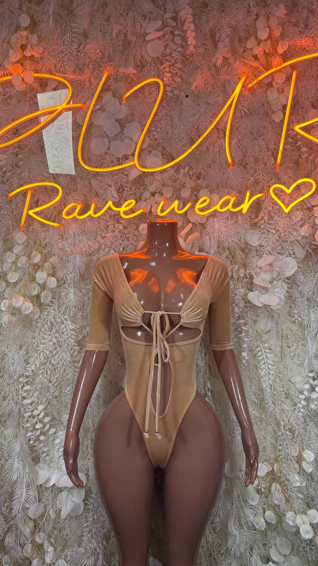 Nude velvet long-sleeve one-piece bodysuit with lace-up front and thong cut