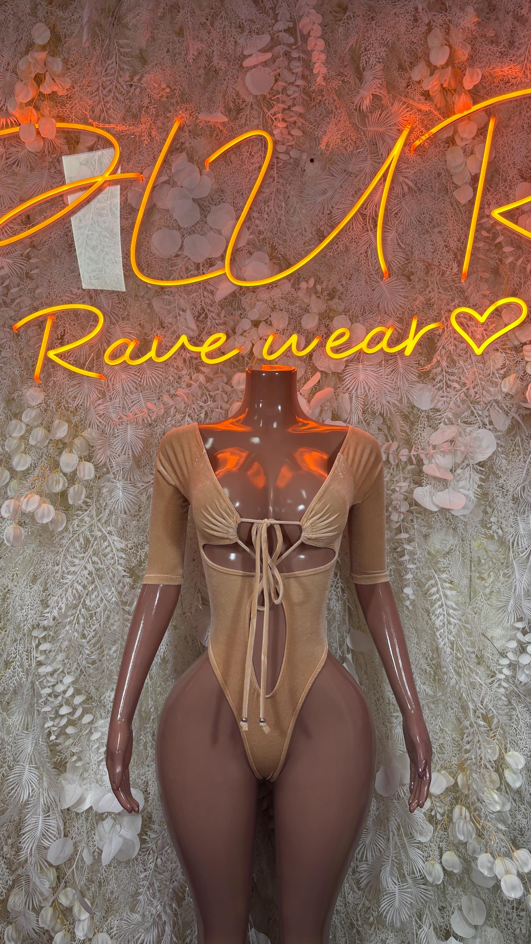 Nude velvet long-sleeve one-piece bodysuit with lace-up front and thong cut