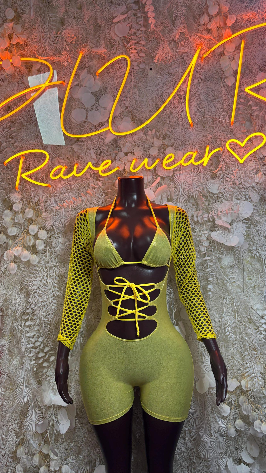 Lime yellow lace-up bodysuit with long mesh sleeves and cutout black front panel