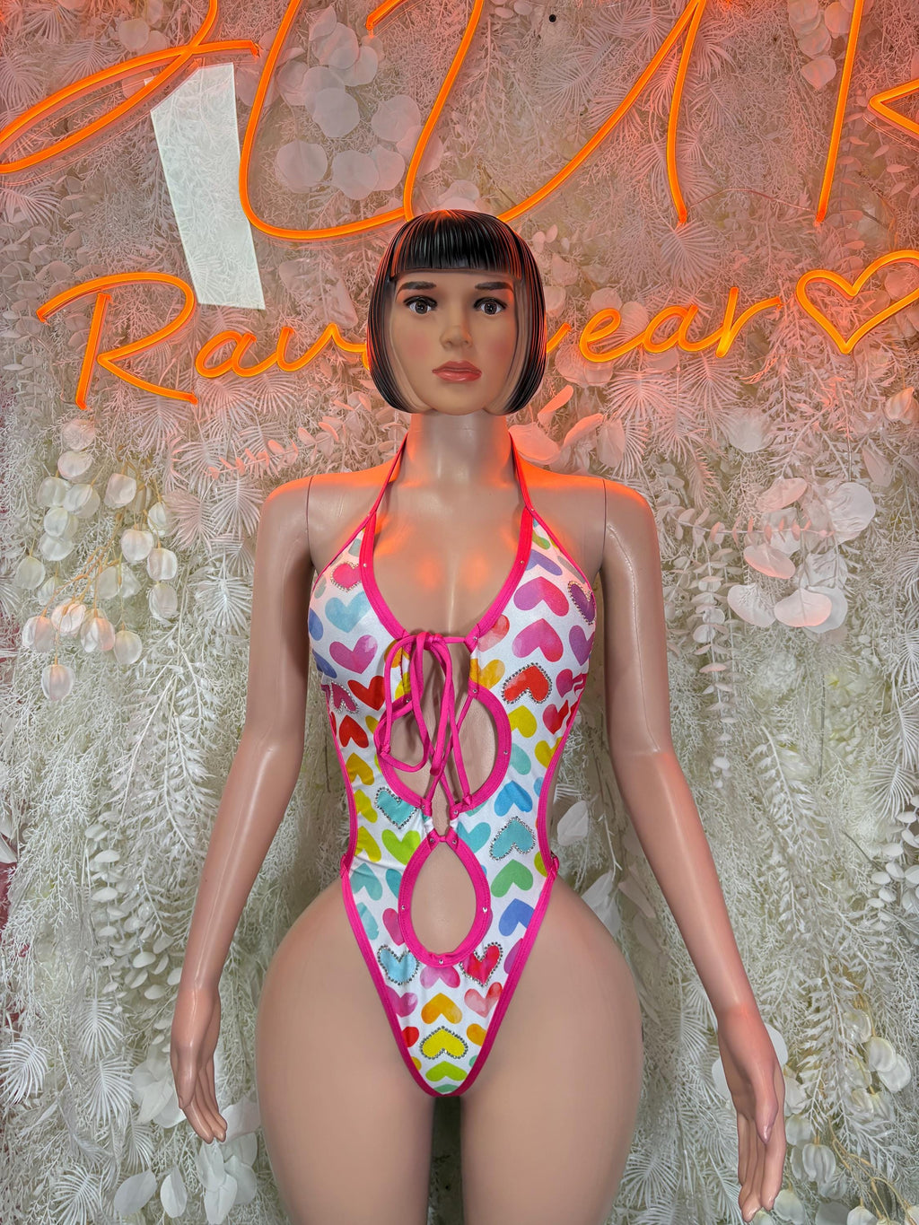 Heart print one-piece bodysuit with pink trim, halter tie front, multicolor hearts