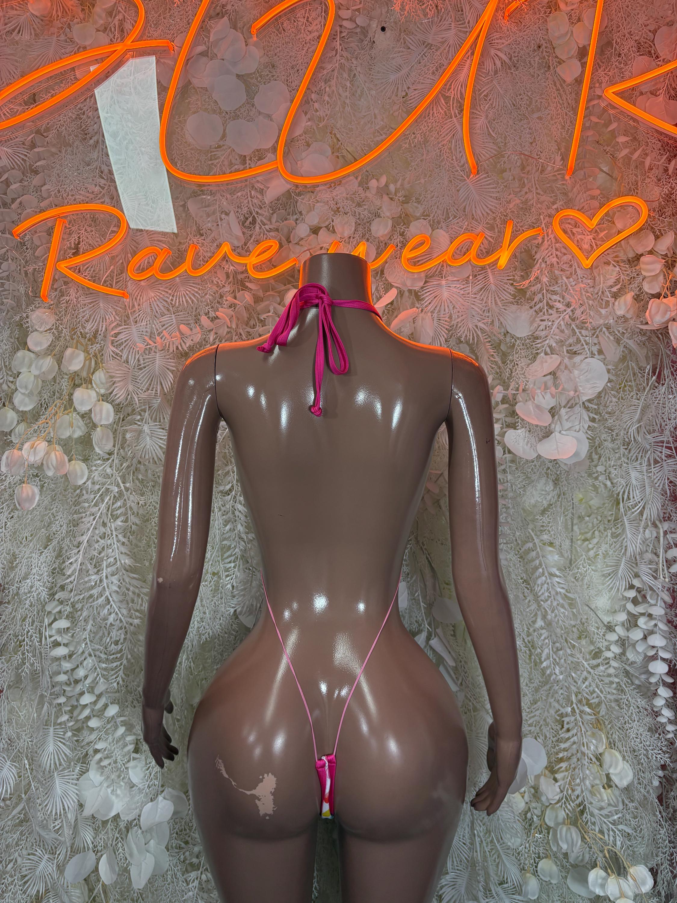 Back view of heart cutout bodysuit with multicolor hearts print and pink string ties