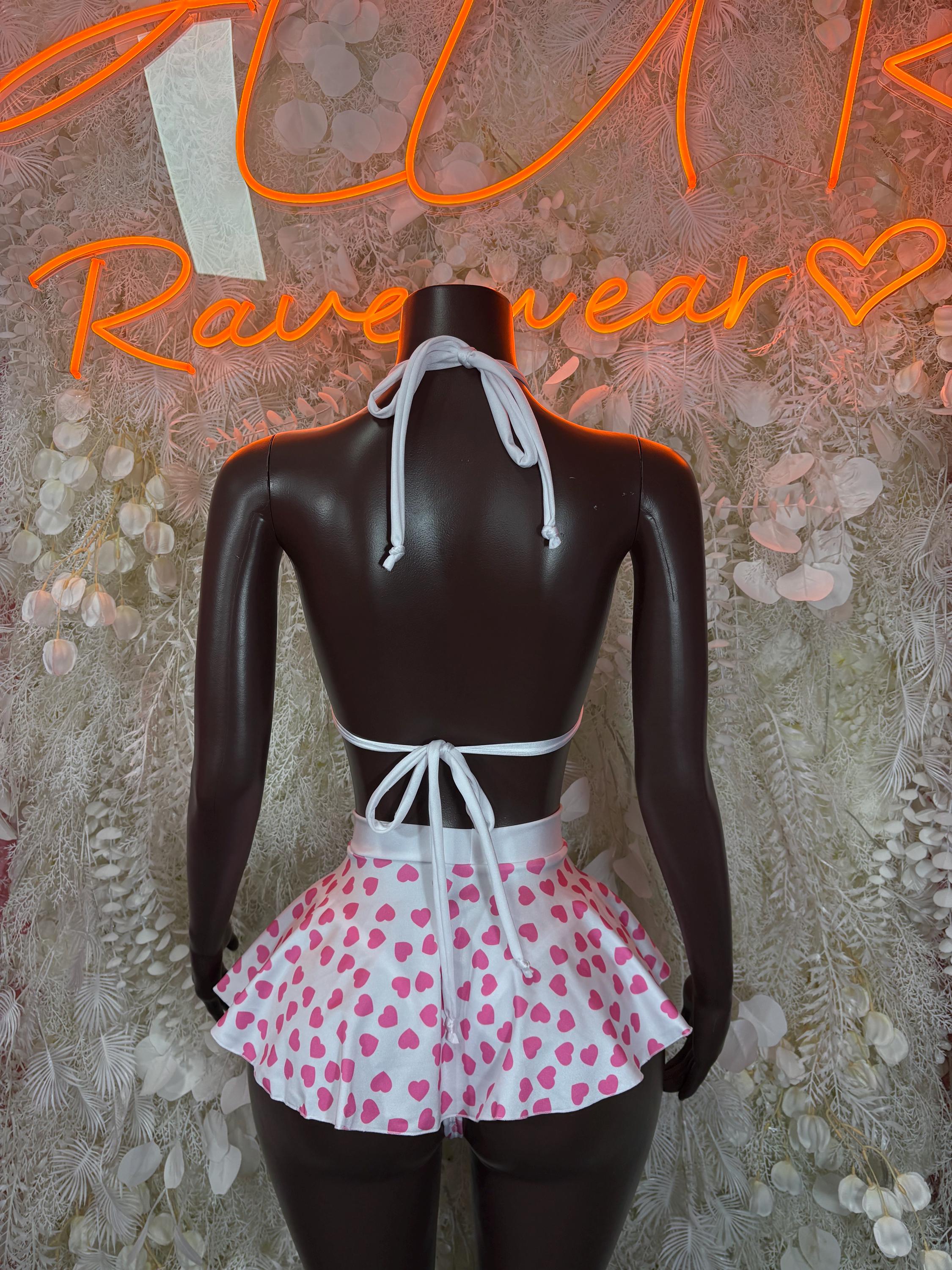 Two-piece mini dress back view with tied halter straps and flared pink heart-print skirt