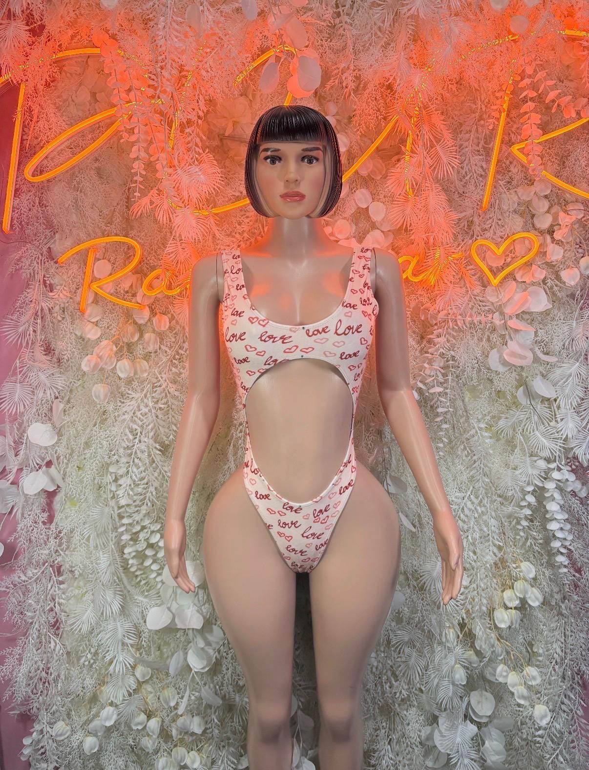 White heart-print thong bodysuit with high-cut legs, short sleeves