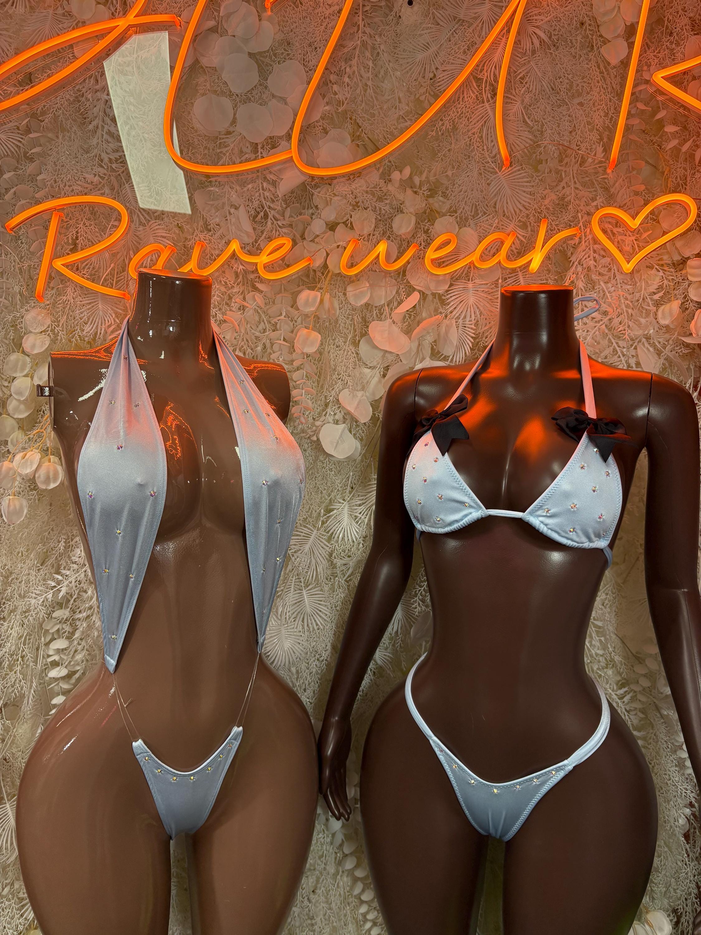 Light blue one-piece dance bodysuit shown front and back view with sheer panels and halter
