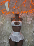 White two-piece skirt set with halter bralette and ruffled micro-skirt