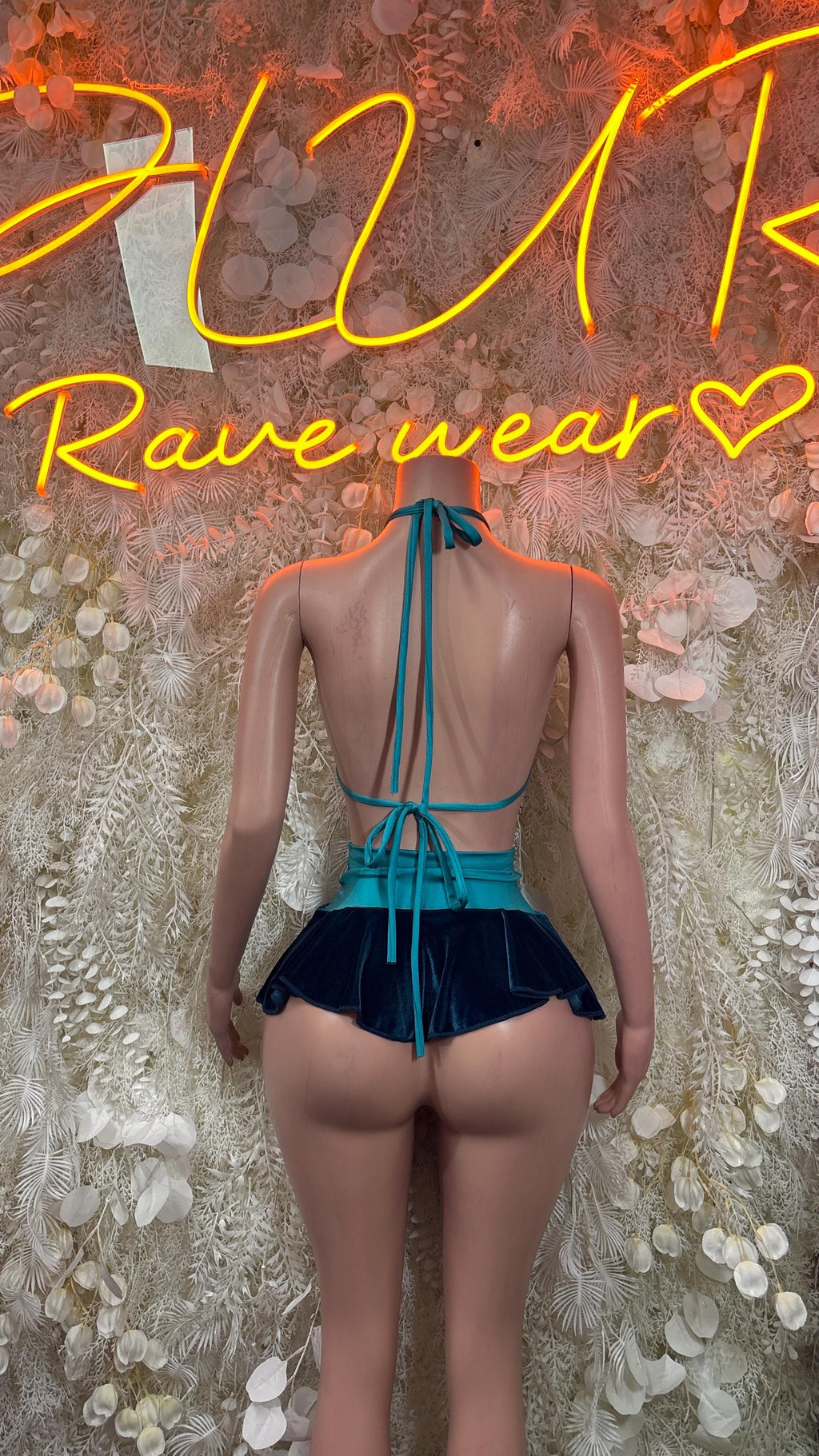 Teal velvet two-piece skirt set, back view with crisscross straps and pleated mini skirt
