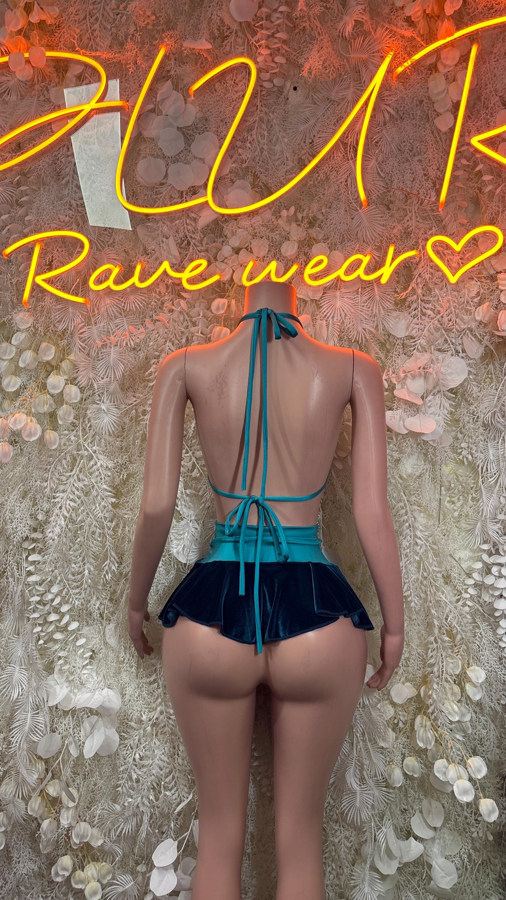 Teal velvet two-piece skirt set, back view with crisscross straps and pleated mini skirt
