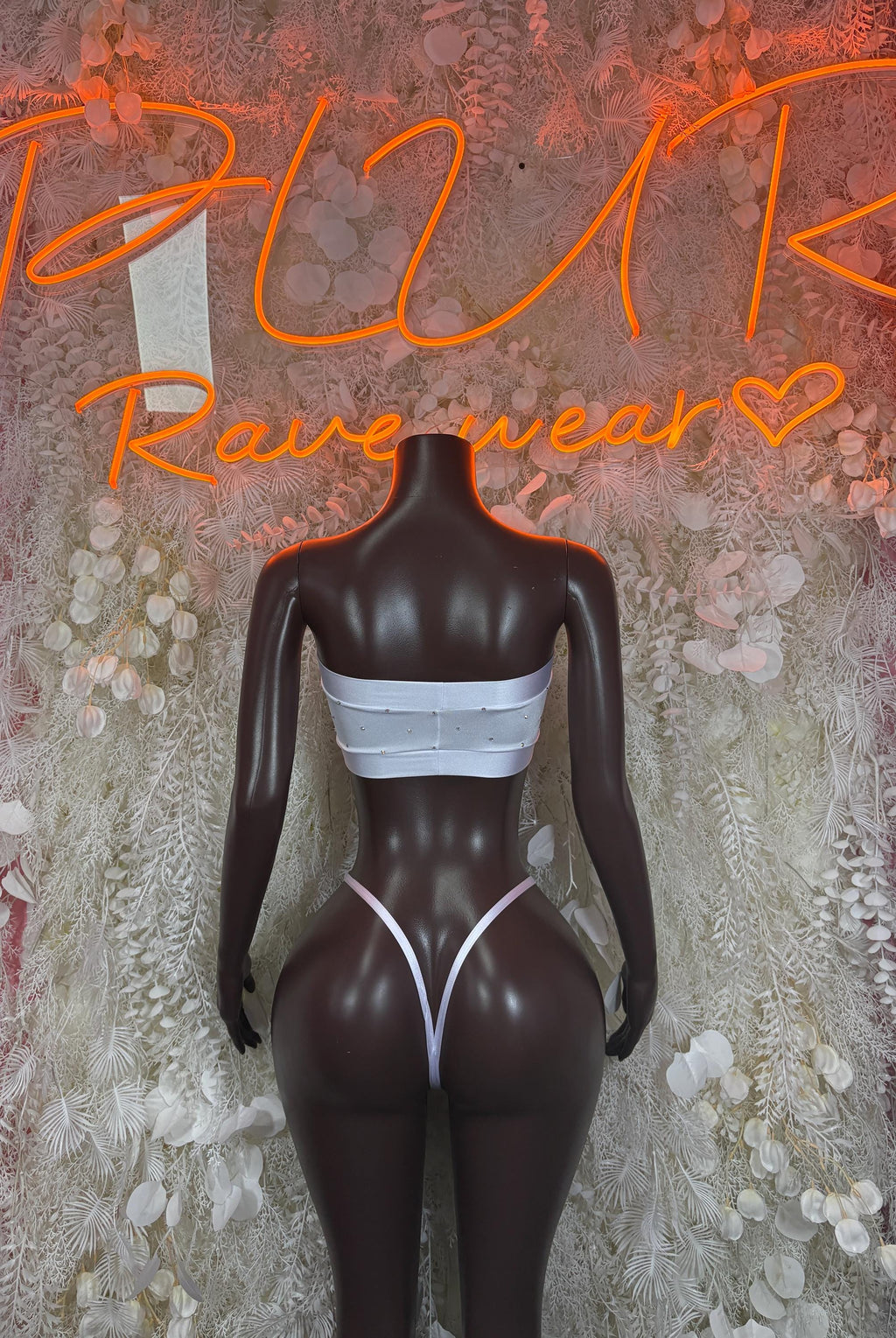 White bikini set with bandeau top and high-cut triangle bottoms on mannequin