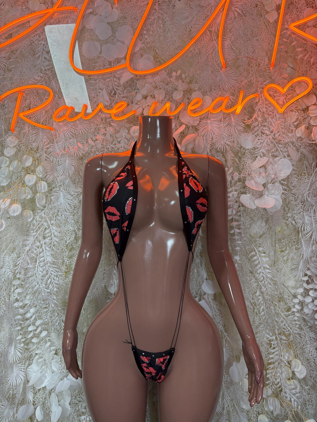 Black sheer lingerie bodysuit with heart cutouts and red kiss print