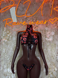 Two-piece lingerie set: black mesh bodysuit with red heart-print lace-up front